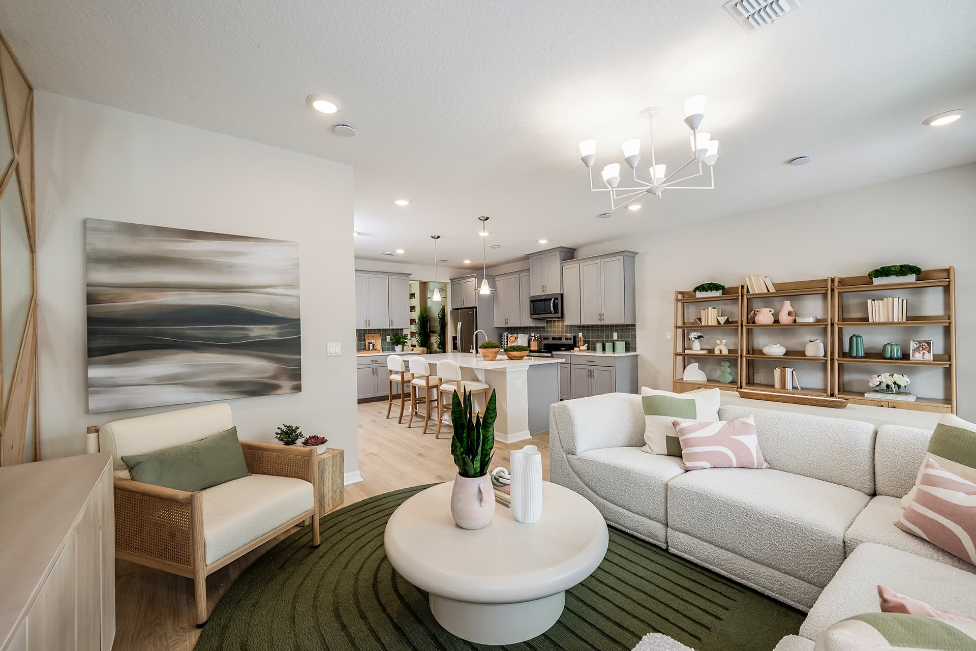 great room with green rug and white sectional