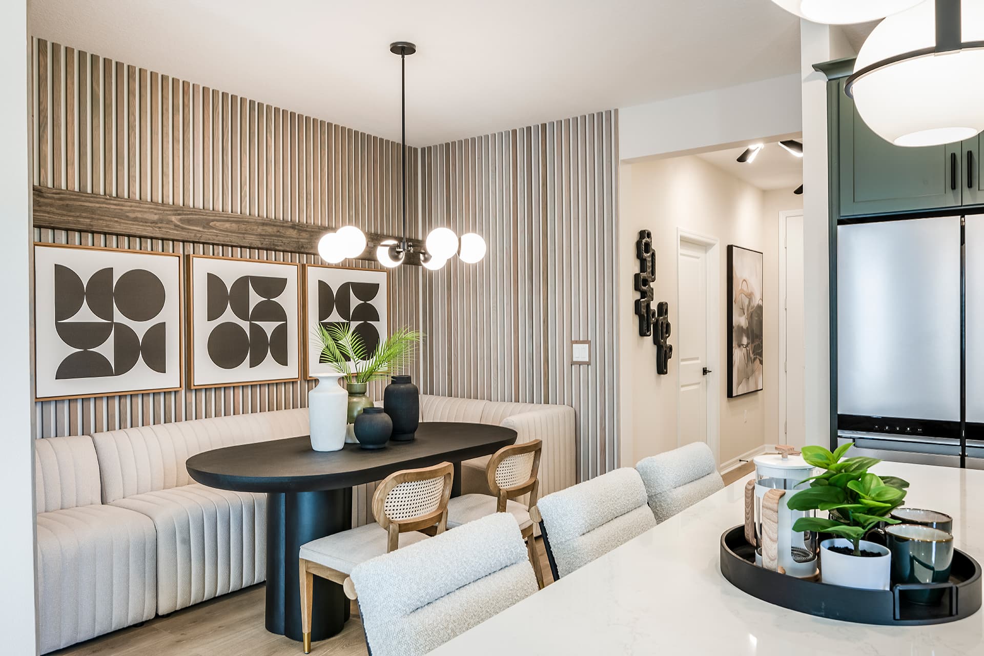 dining room with black table and banquette seating