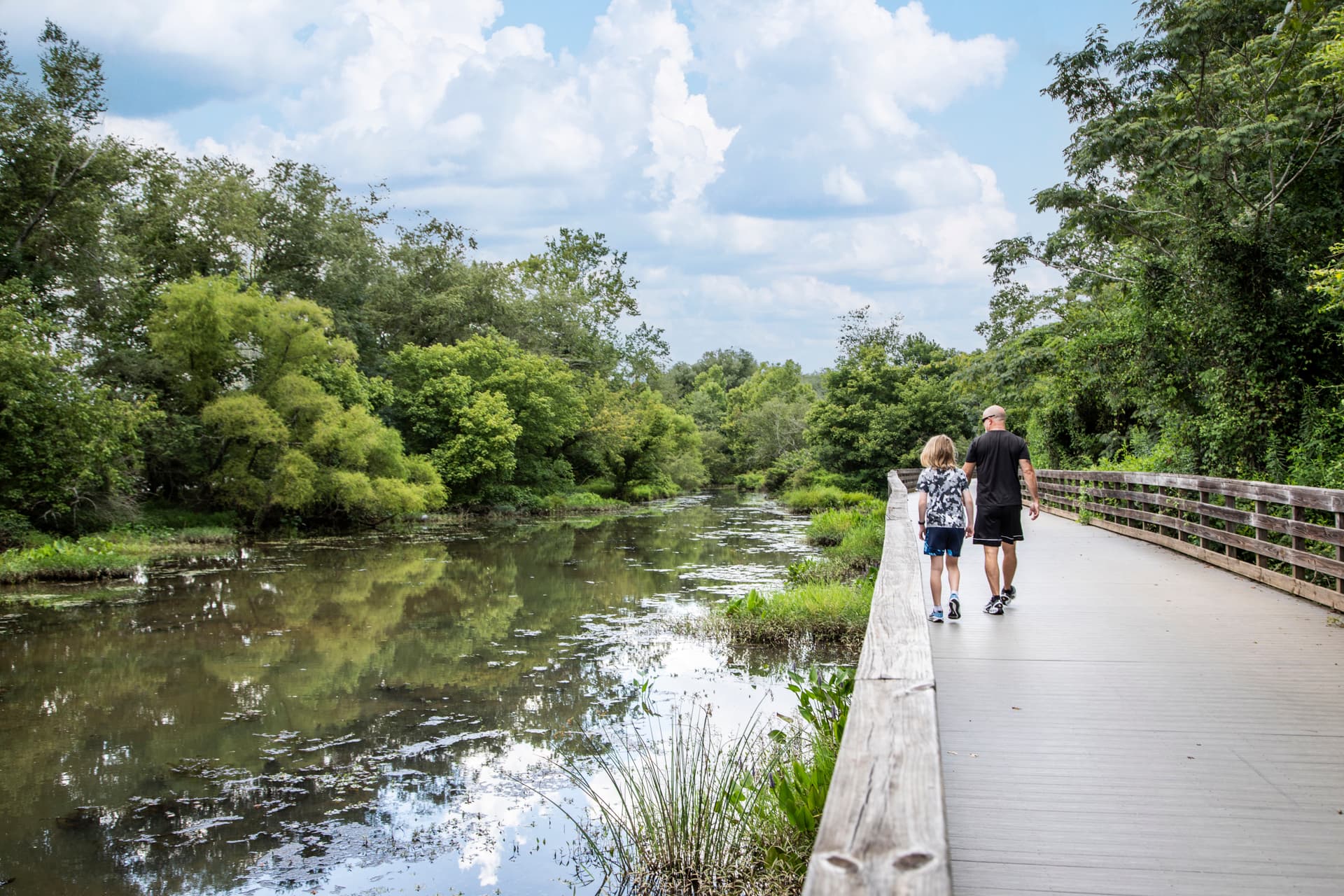 roswell riverwalk with people walking & trees