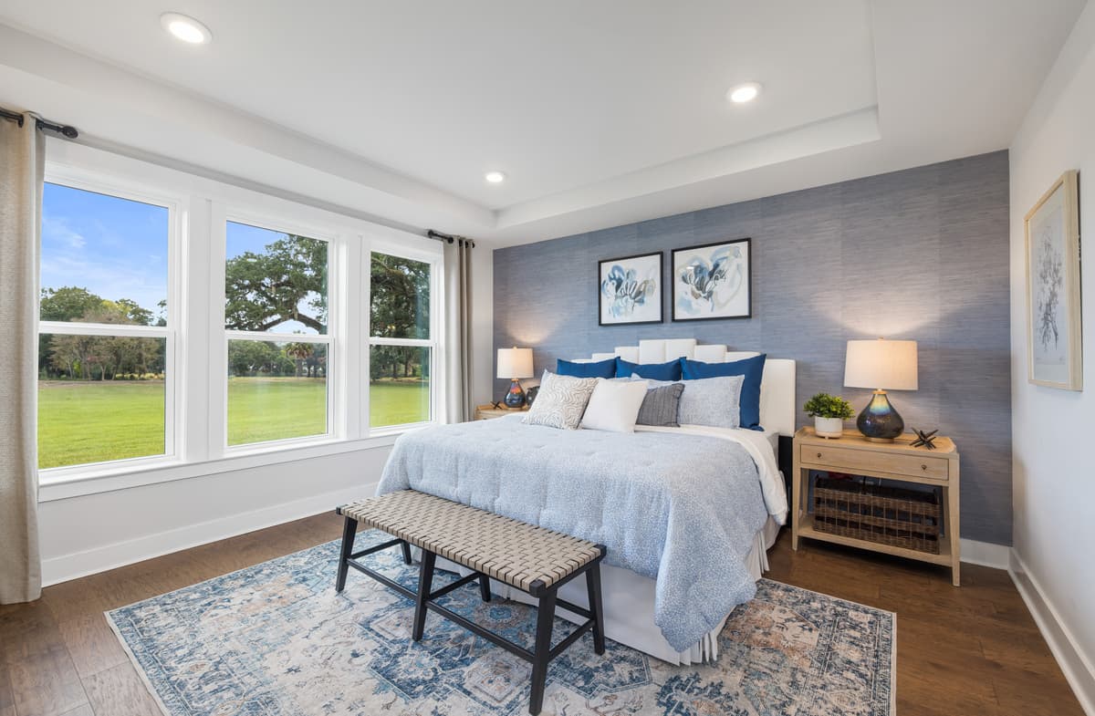 primary bedroom with three large windows