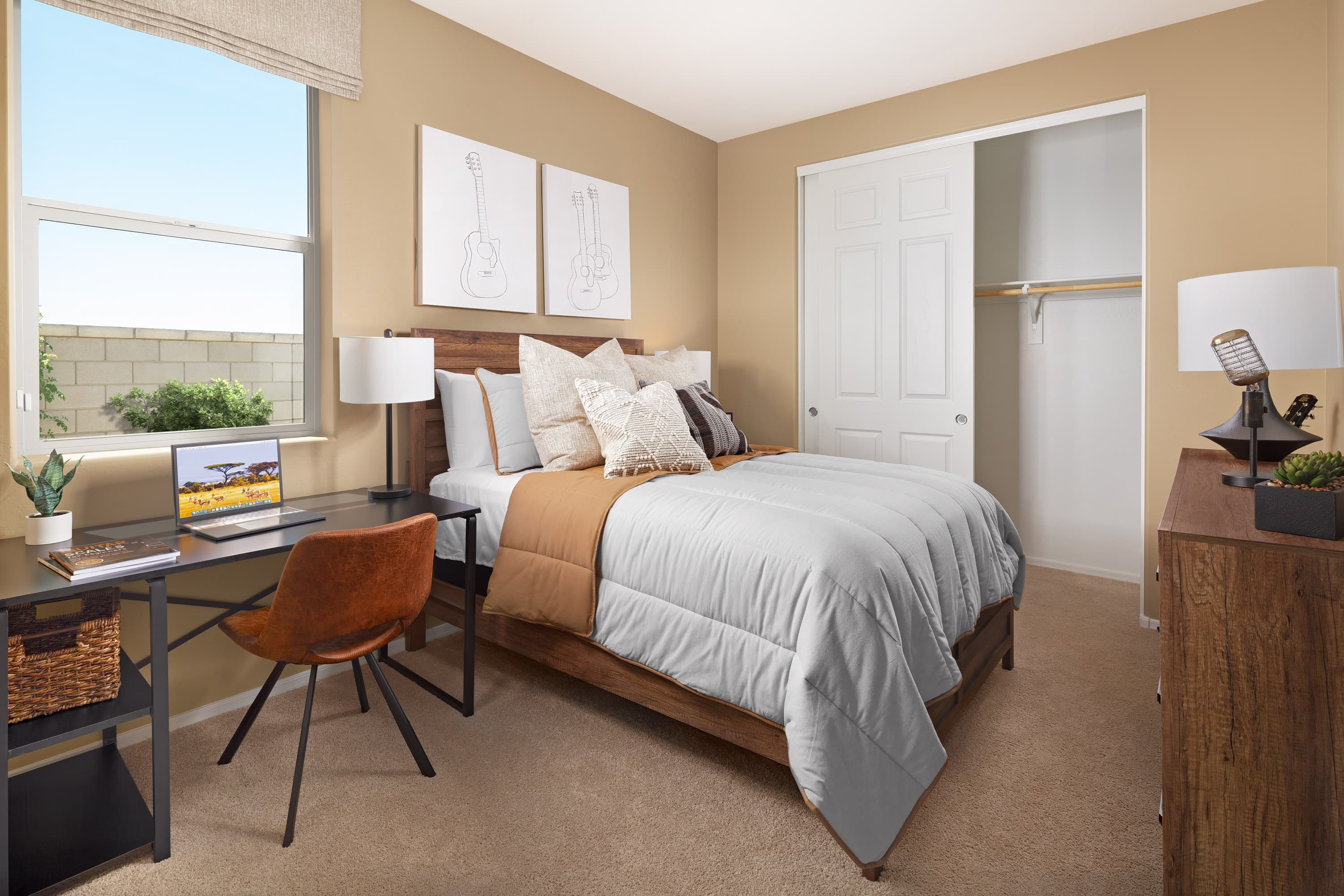 secondary bedroom with bed, wall art, and desk