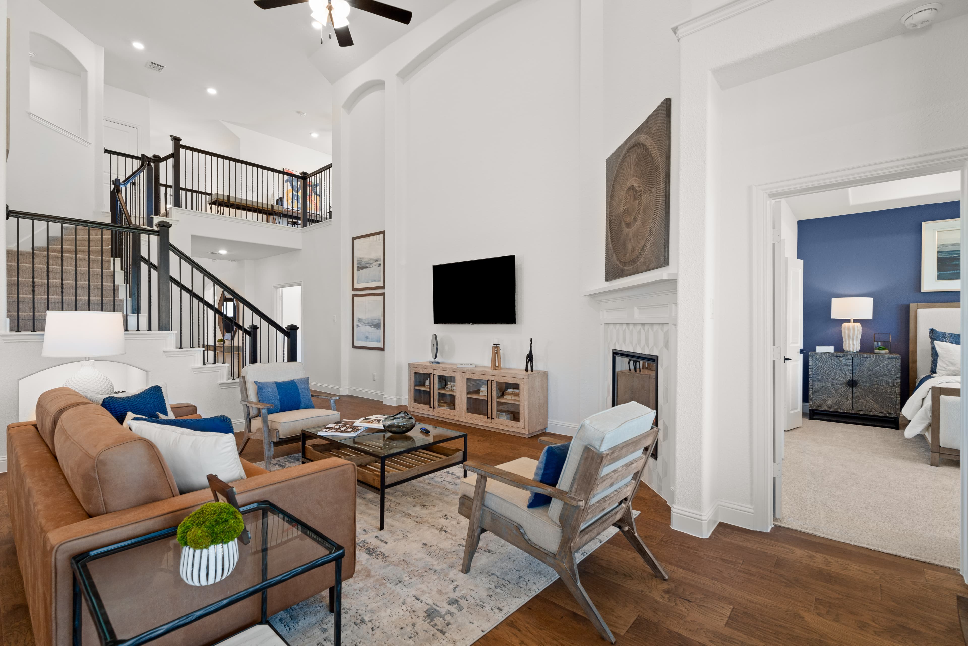 open great room with tall ceiling and wood floors