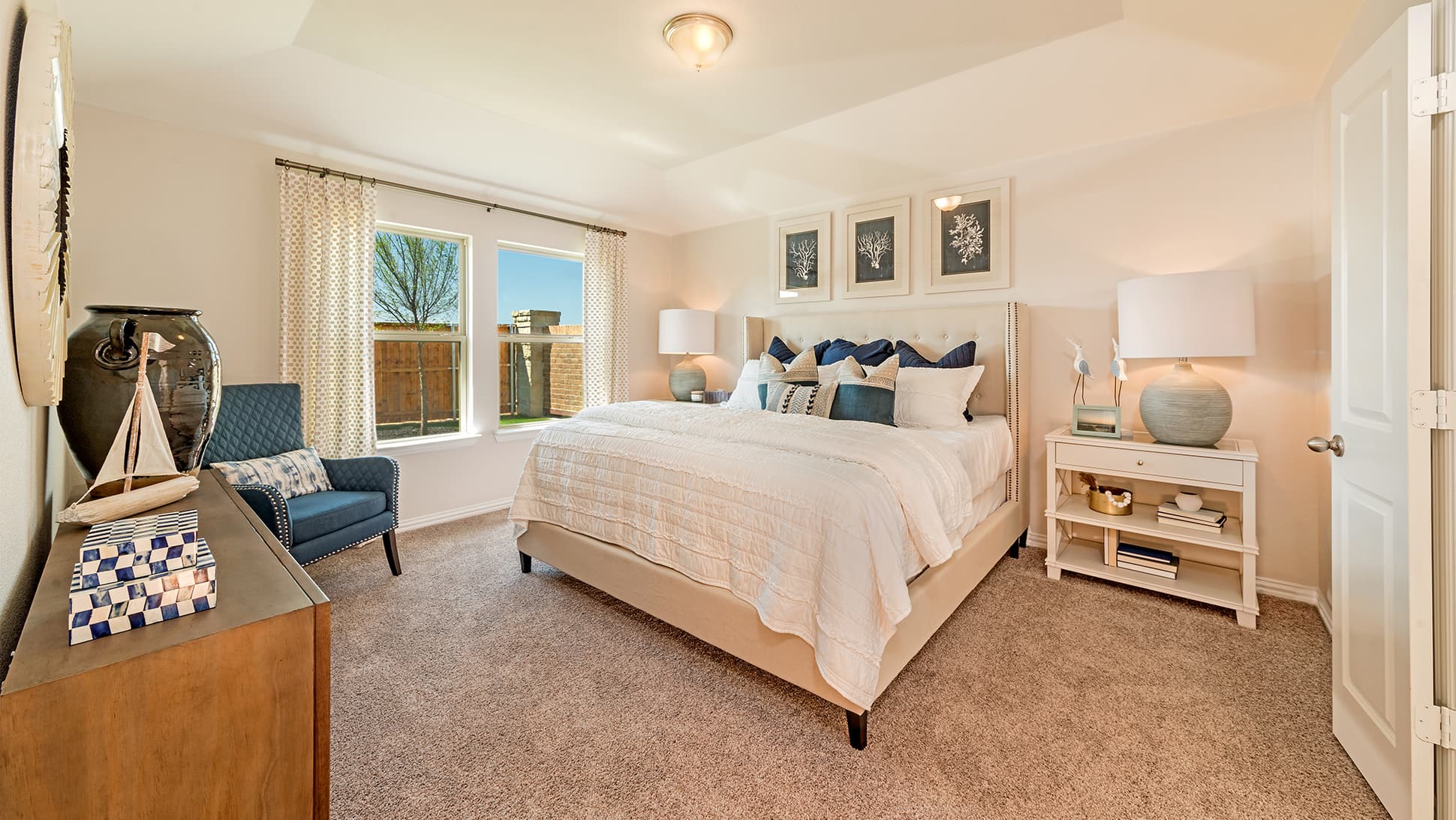 primary bedroom with a tray ceiling