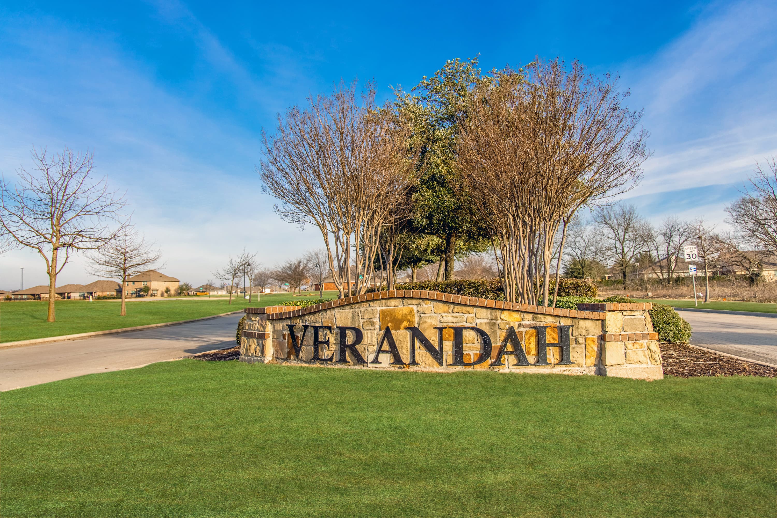 neighborhood entrance sign with brown stone