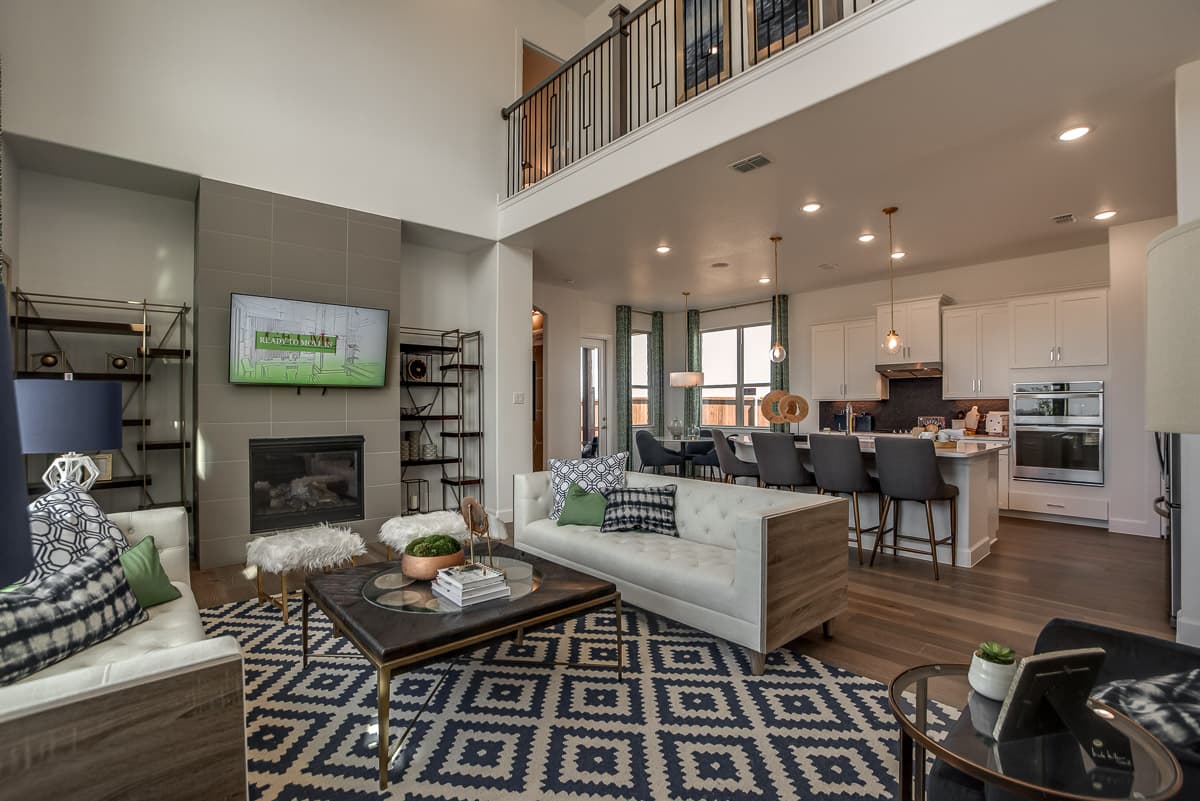 great room with wood floors and soaring ceilings 