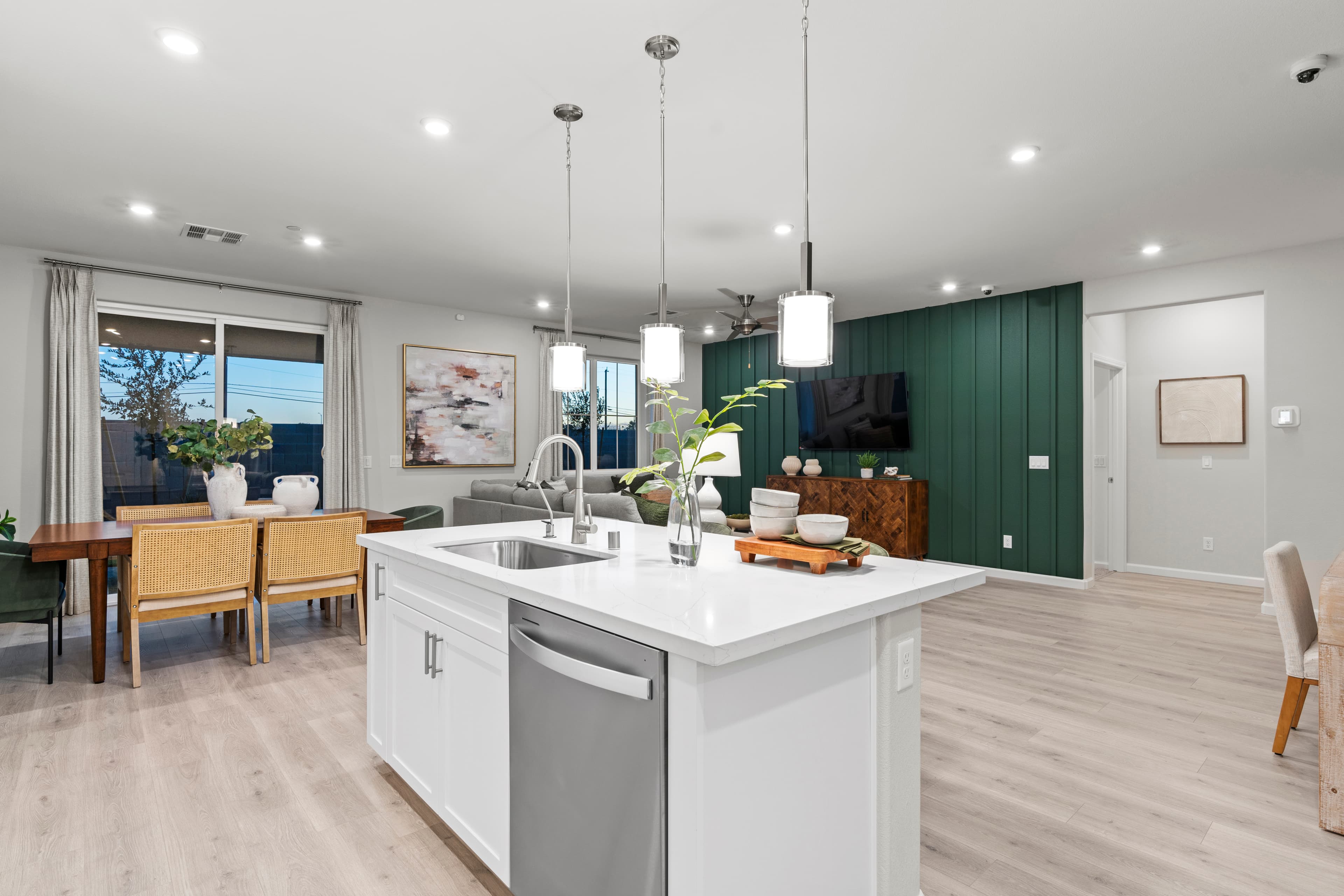 great room with white countertops and accent wall