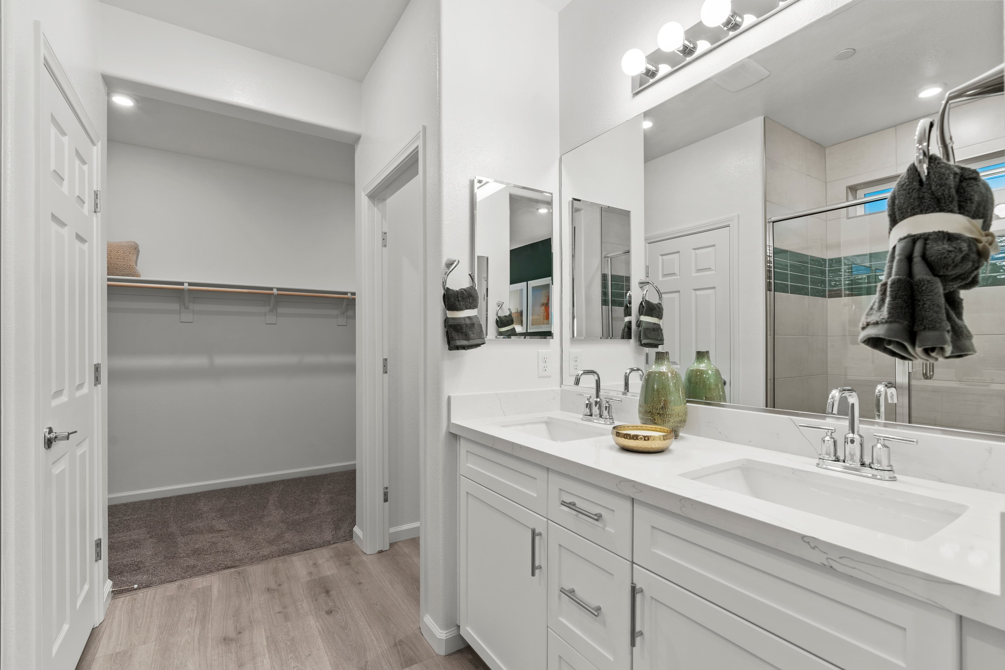 white countertops, cabinets, and walk-in closet