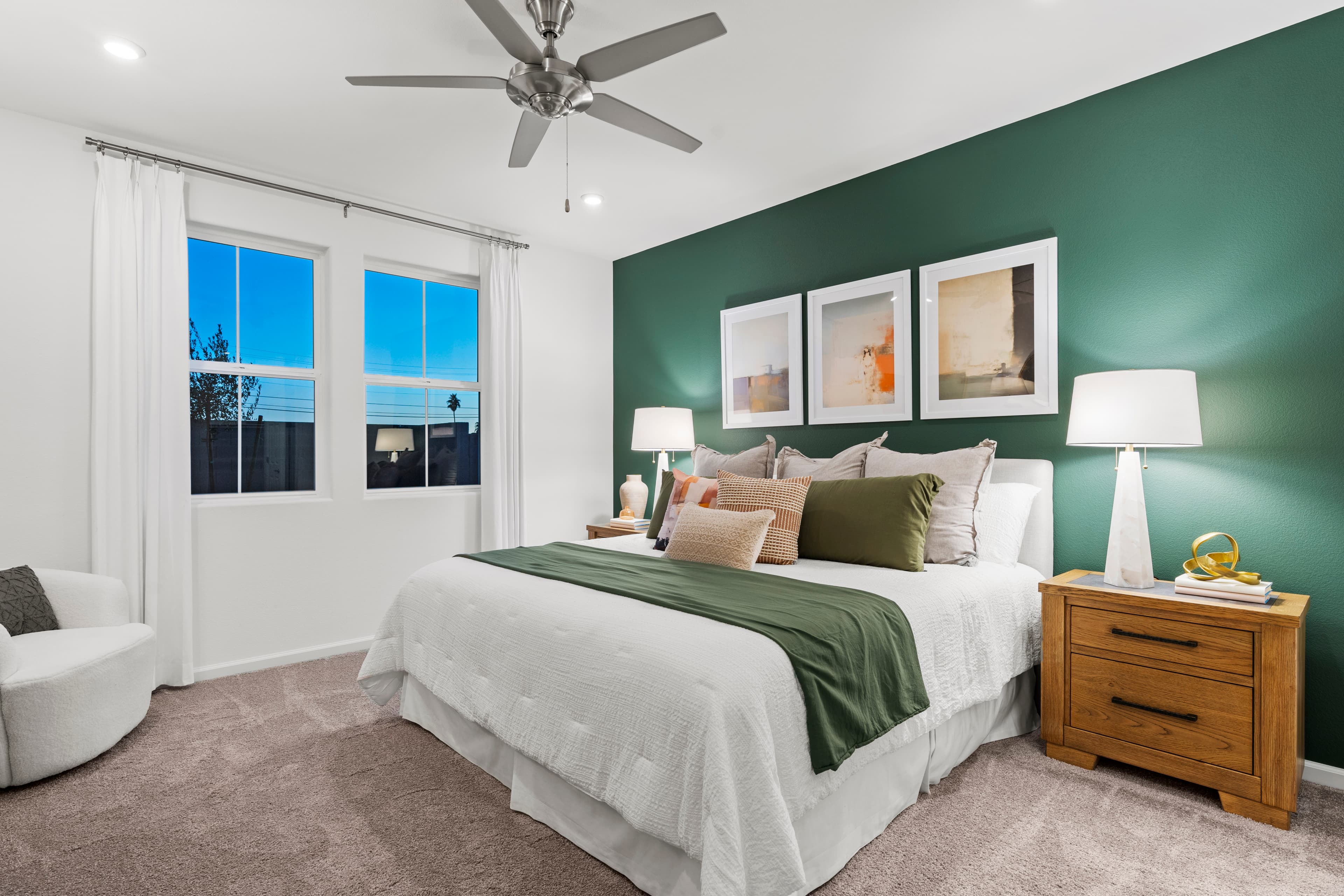 primary bedroom with large bed and accent wall