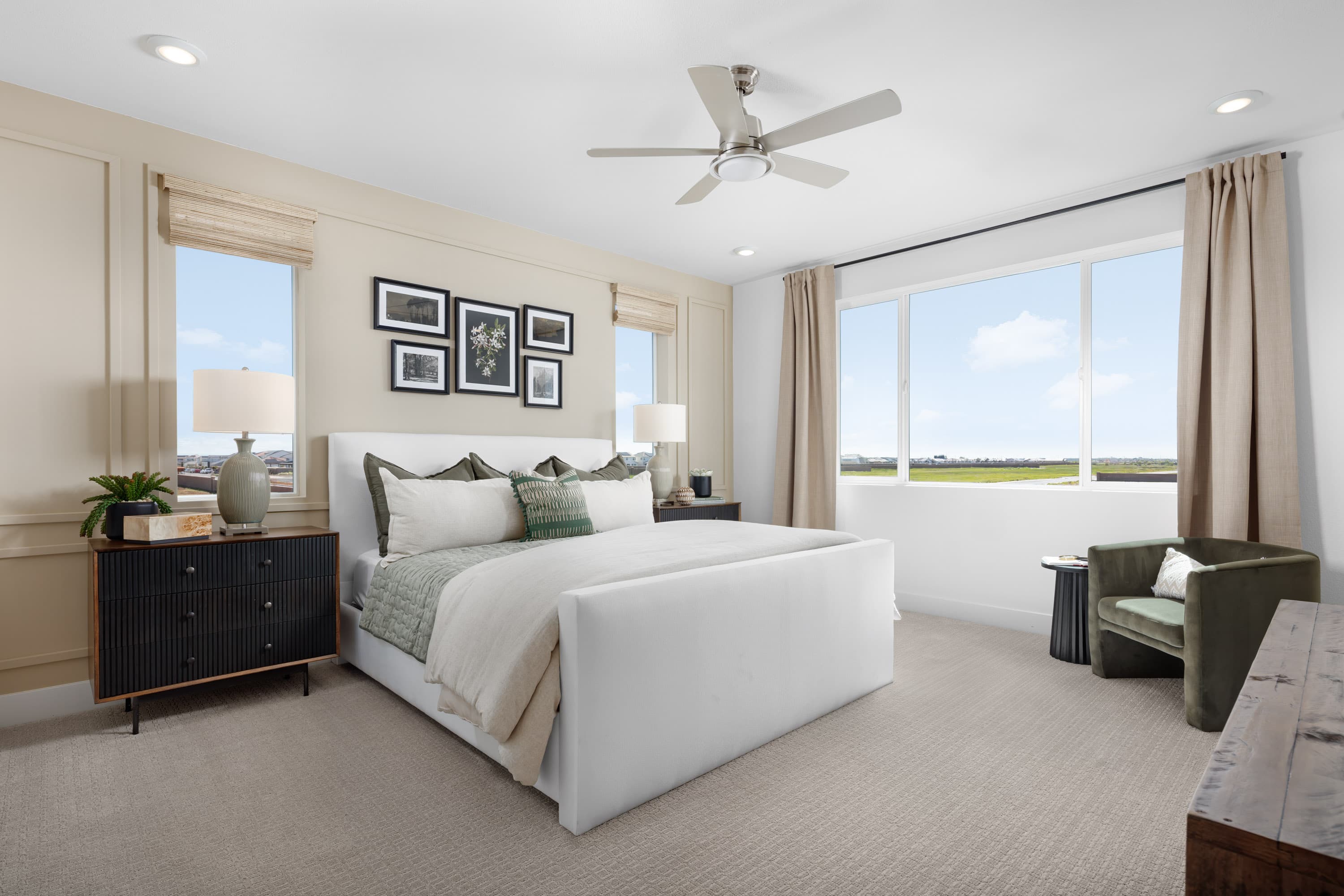 bedroom with tan carpet and white upholstered bed