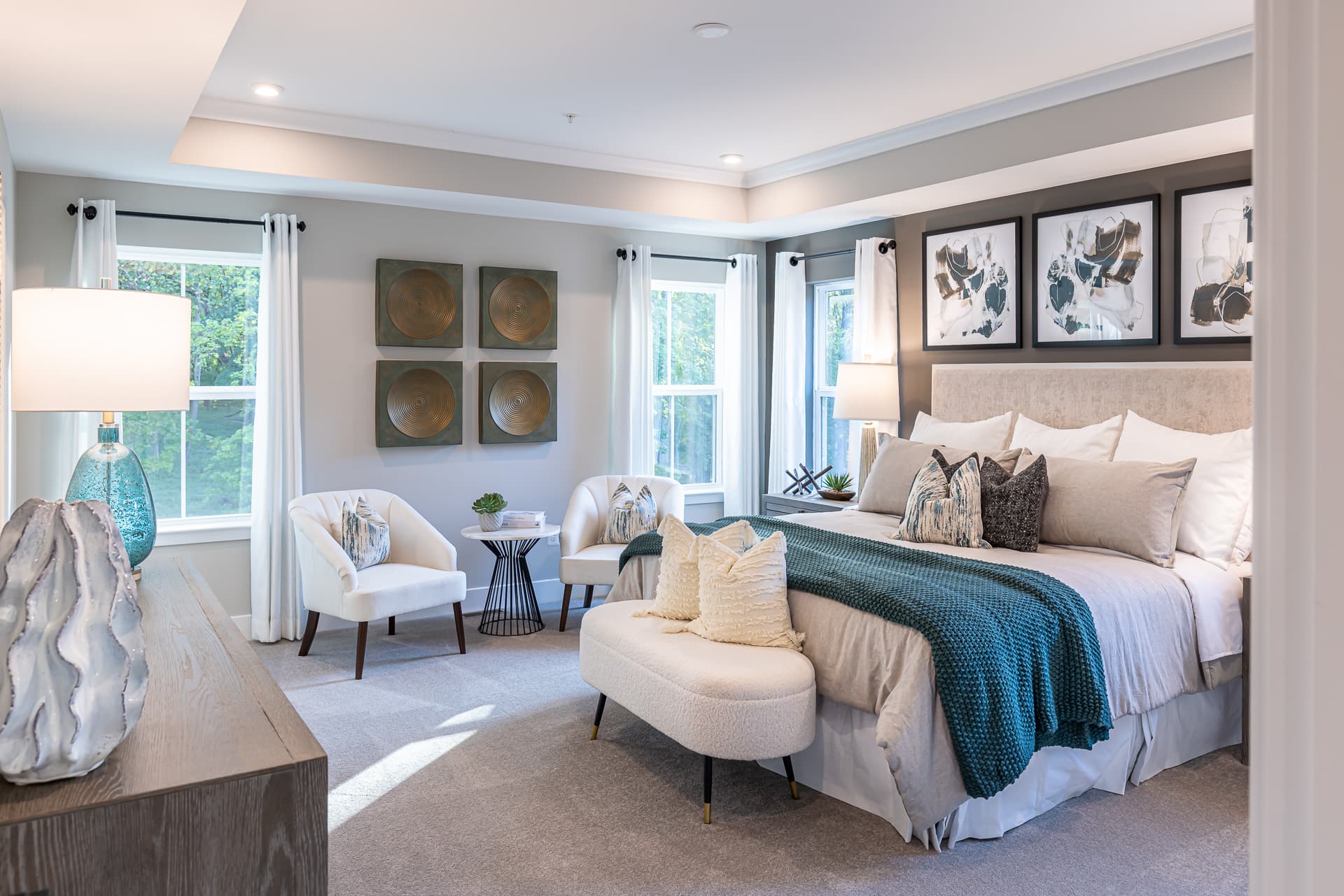 primary suite with a box ceiling and carpet