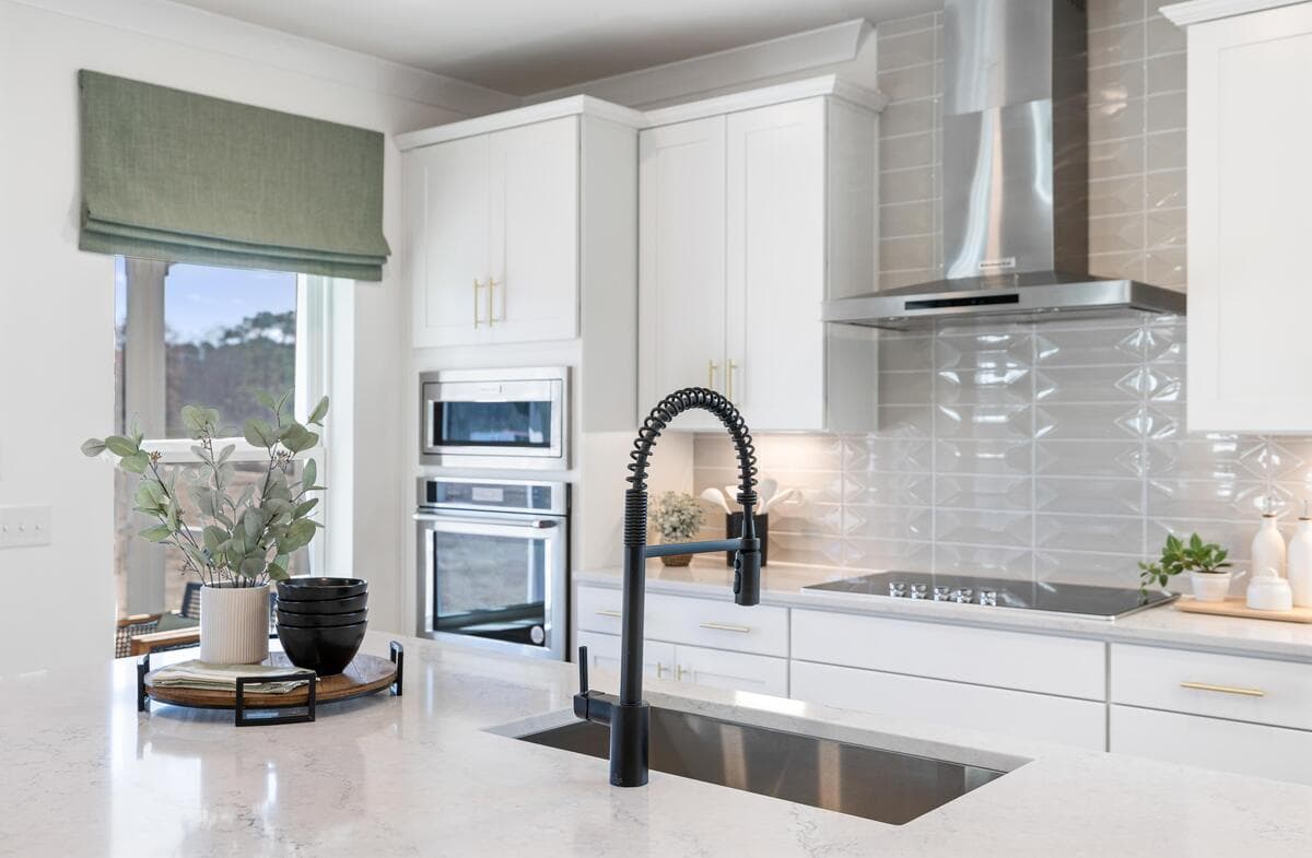 kitchen with microwave oven combo and black faucet