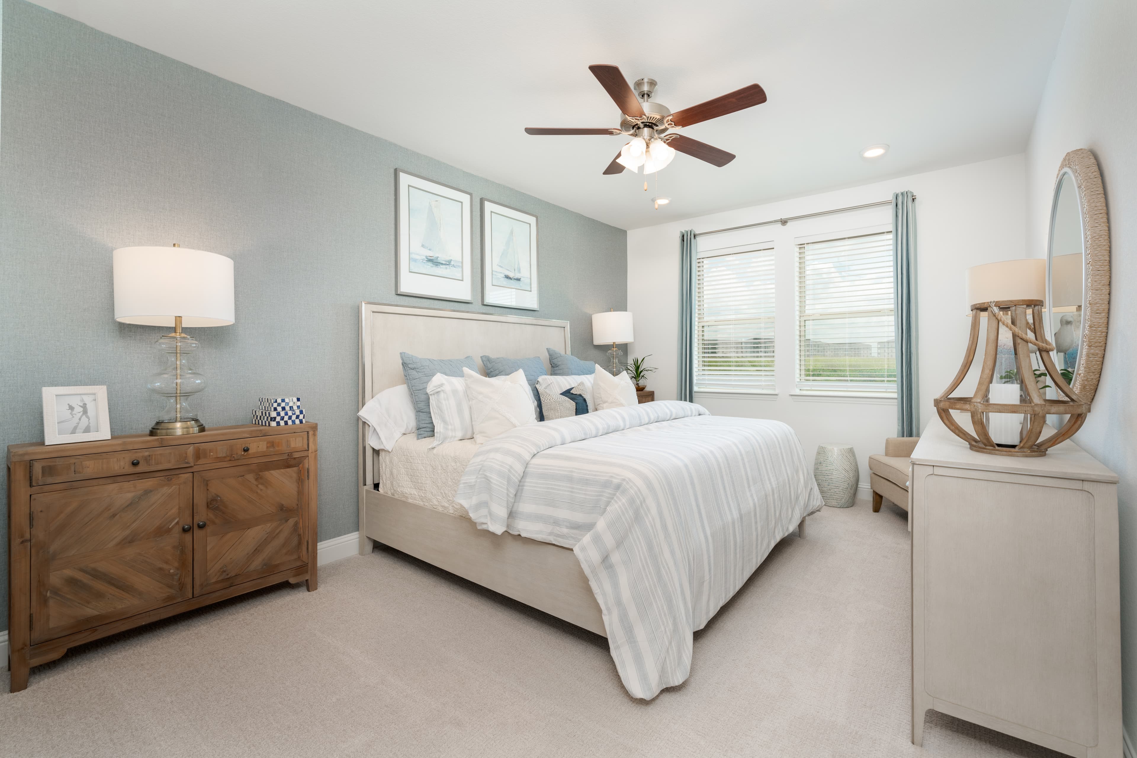 primary bedroom with accent wall and windows
