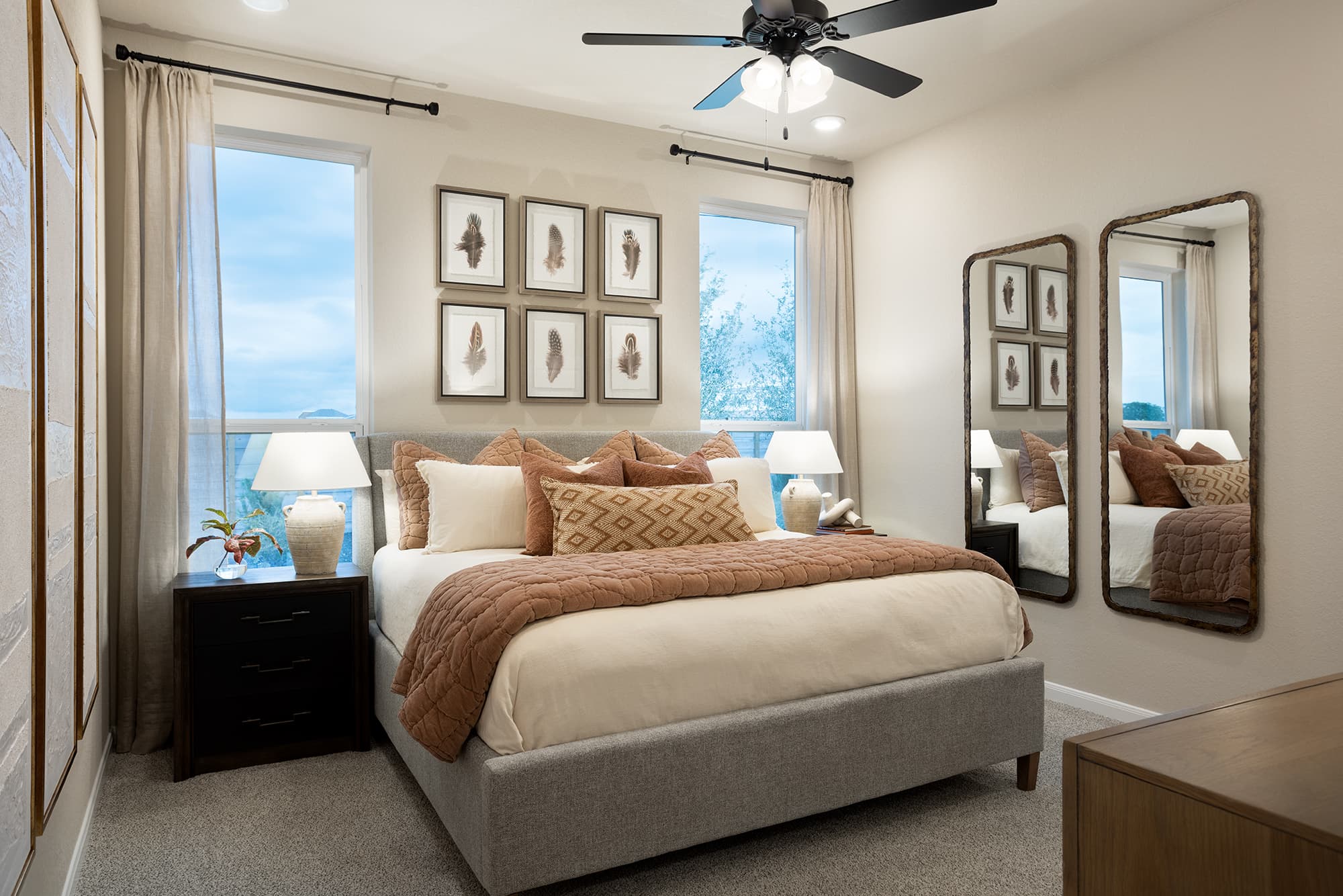 bedroom with ceiling fan, carpet & nightstands 