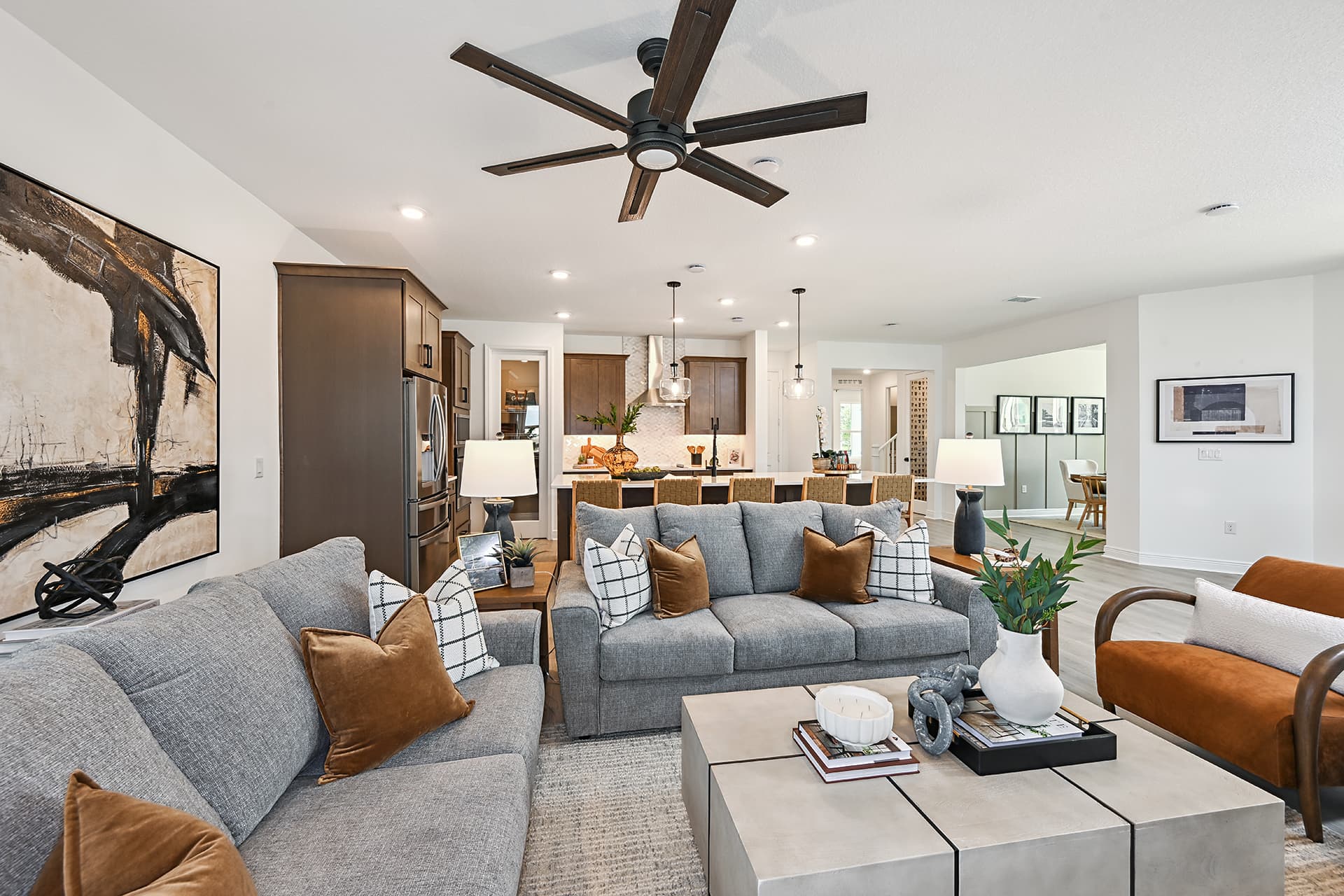 great room with gray couches and ceiling fan