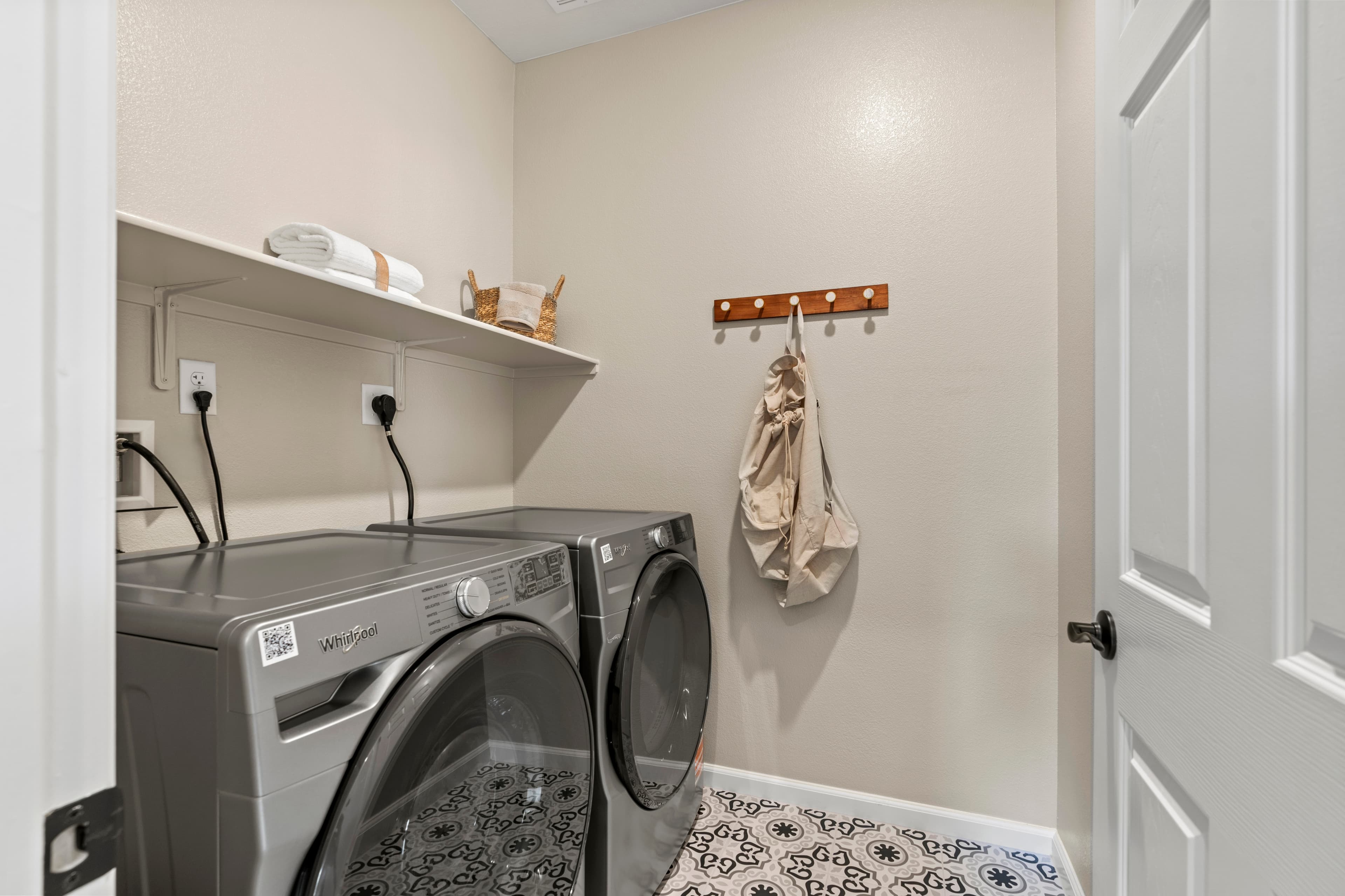 spacious laundry room with tile floors