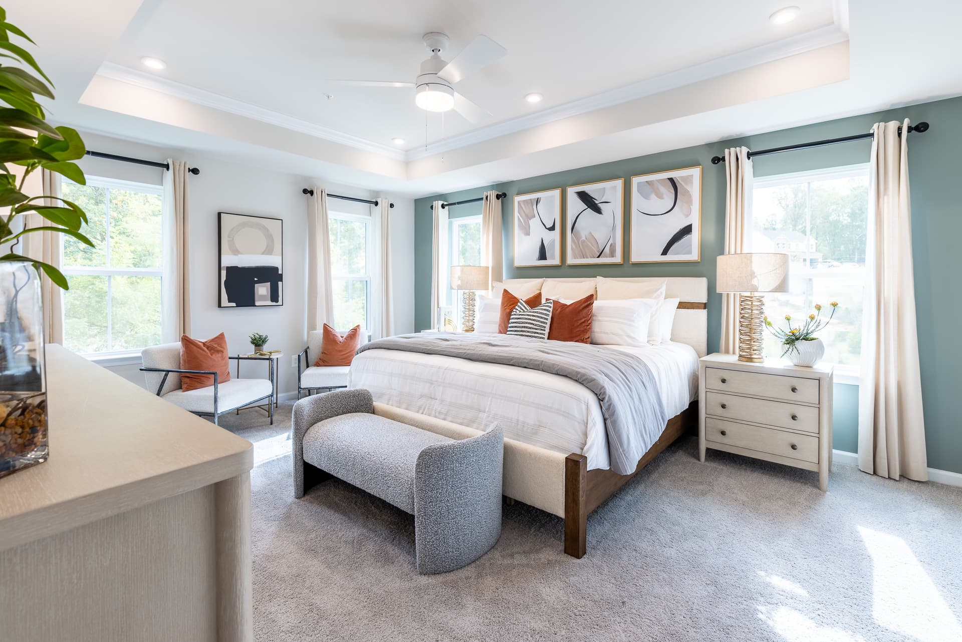 primary suite with a box ceiling and carpet