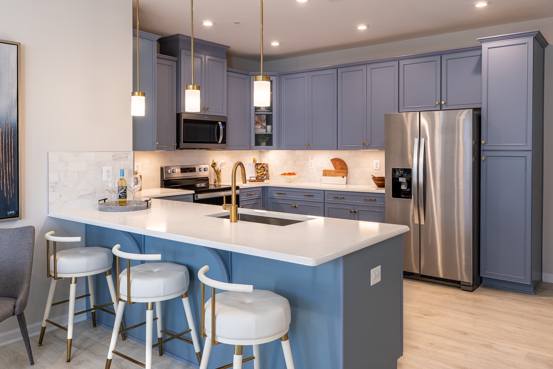 kitchen with a blue breakfast bar & barstools