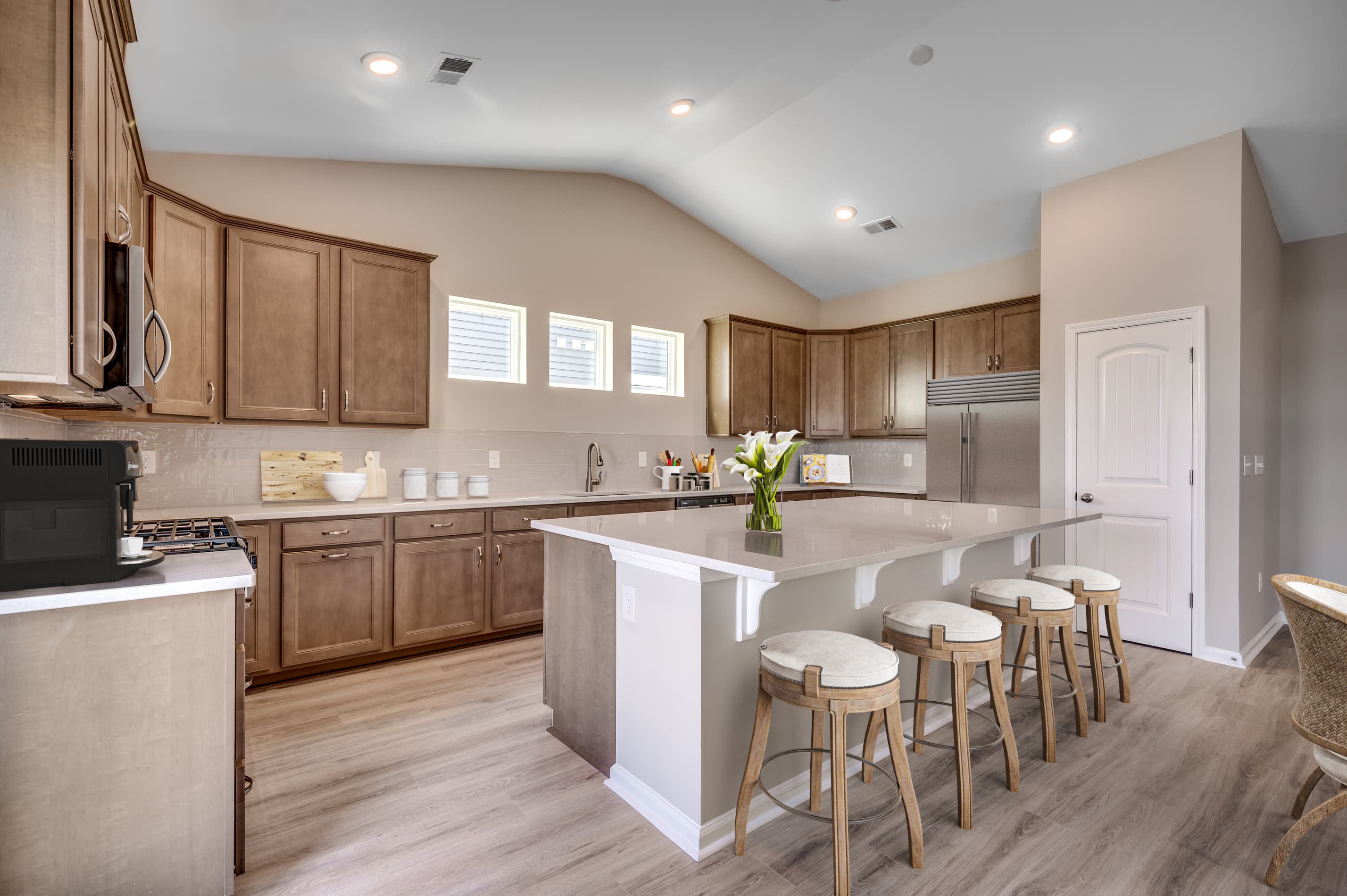 large kitchen island and brown cabinets