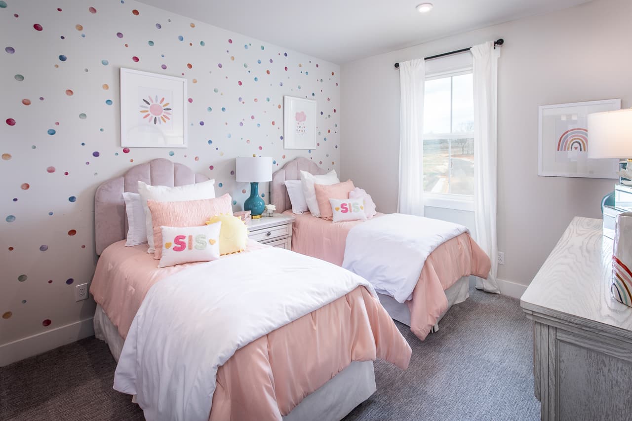 secondary bedroom with neutral carpet & twin beds