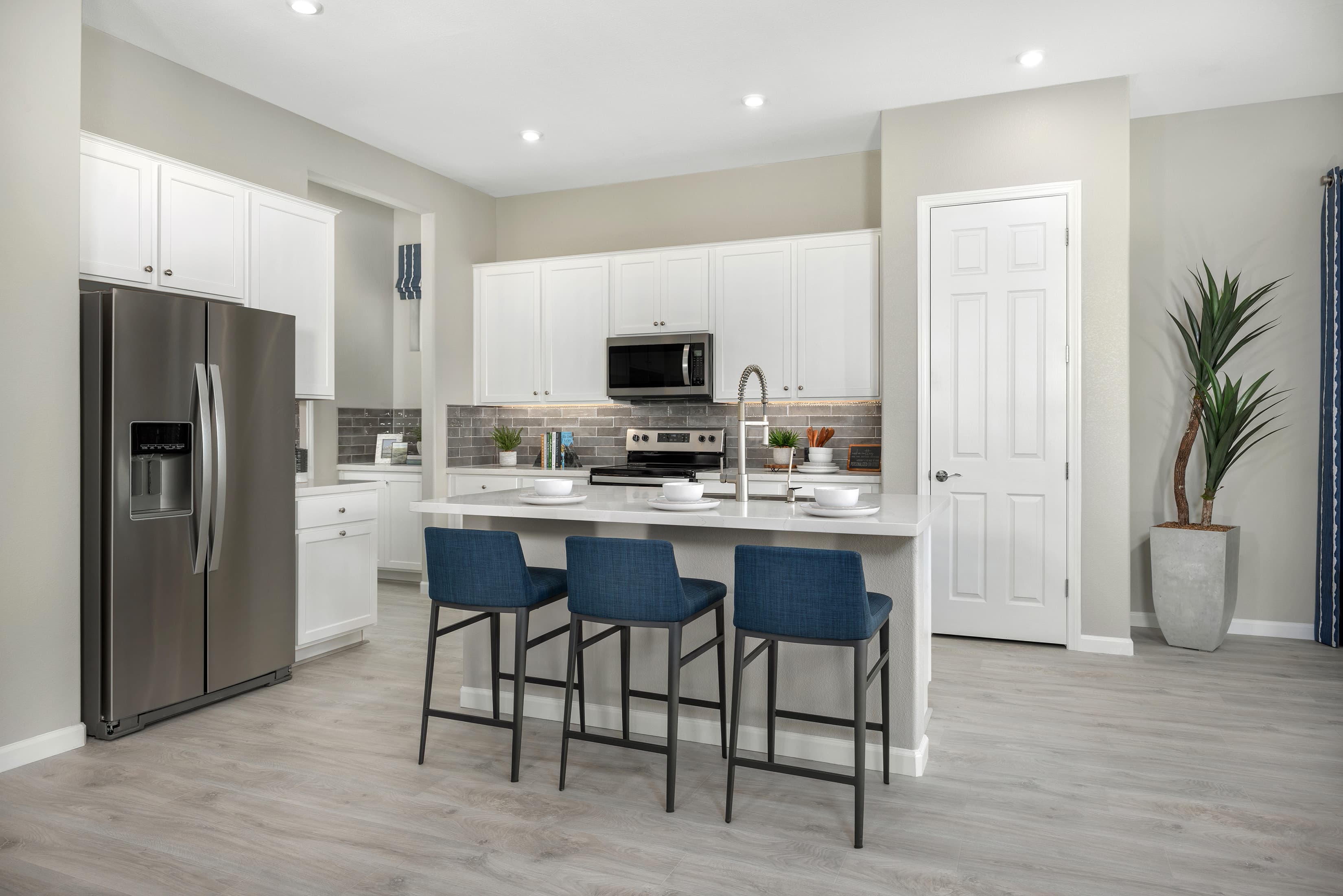 open and airy kitchen with white cabinets 