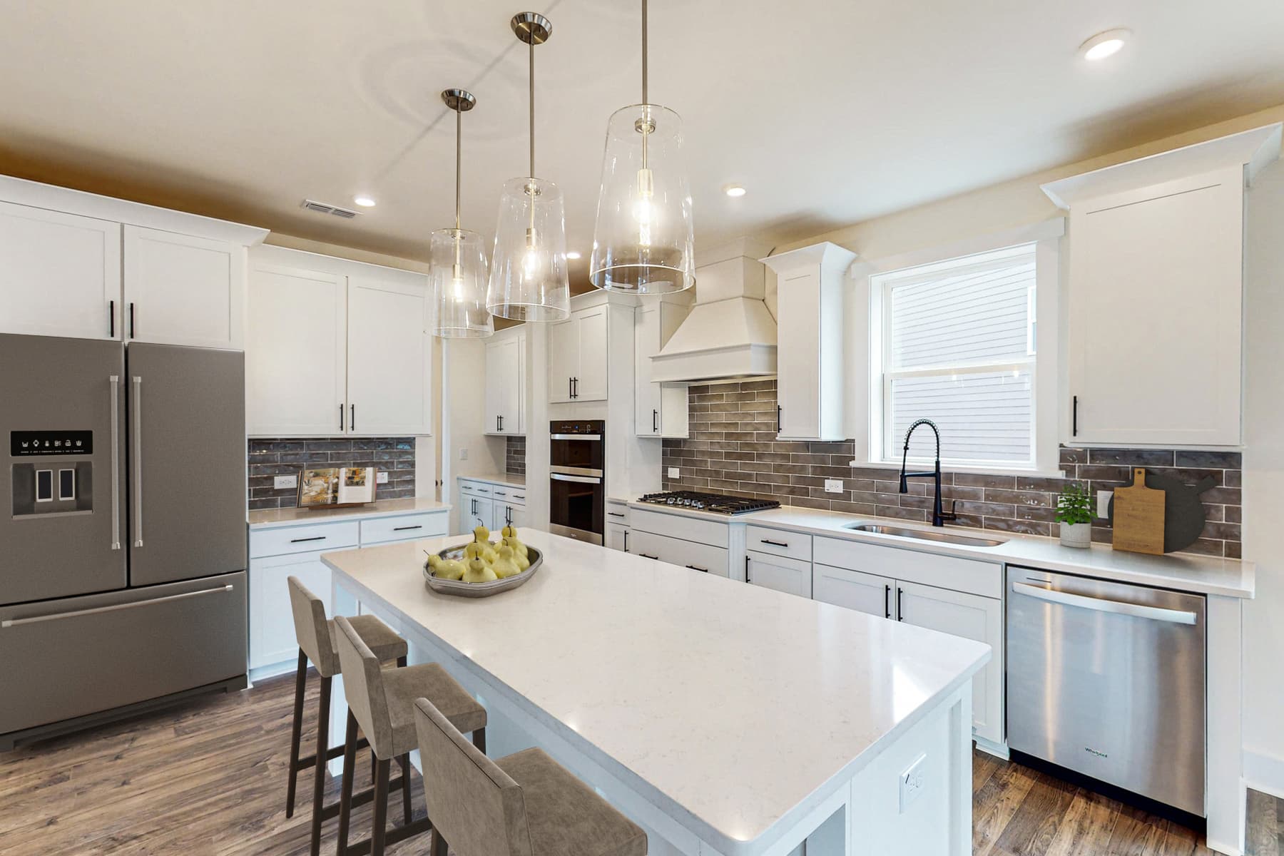 large kitchen with island and white cabinets