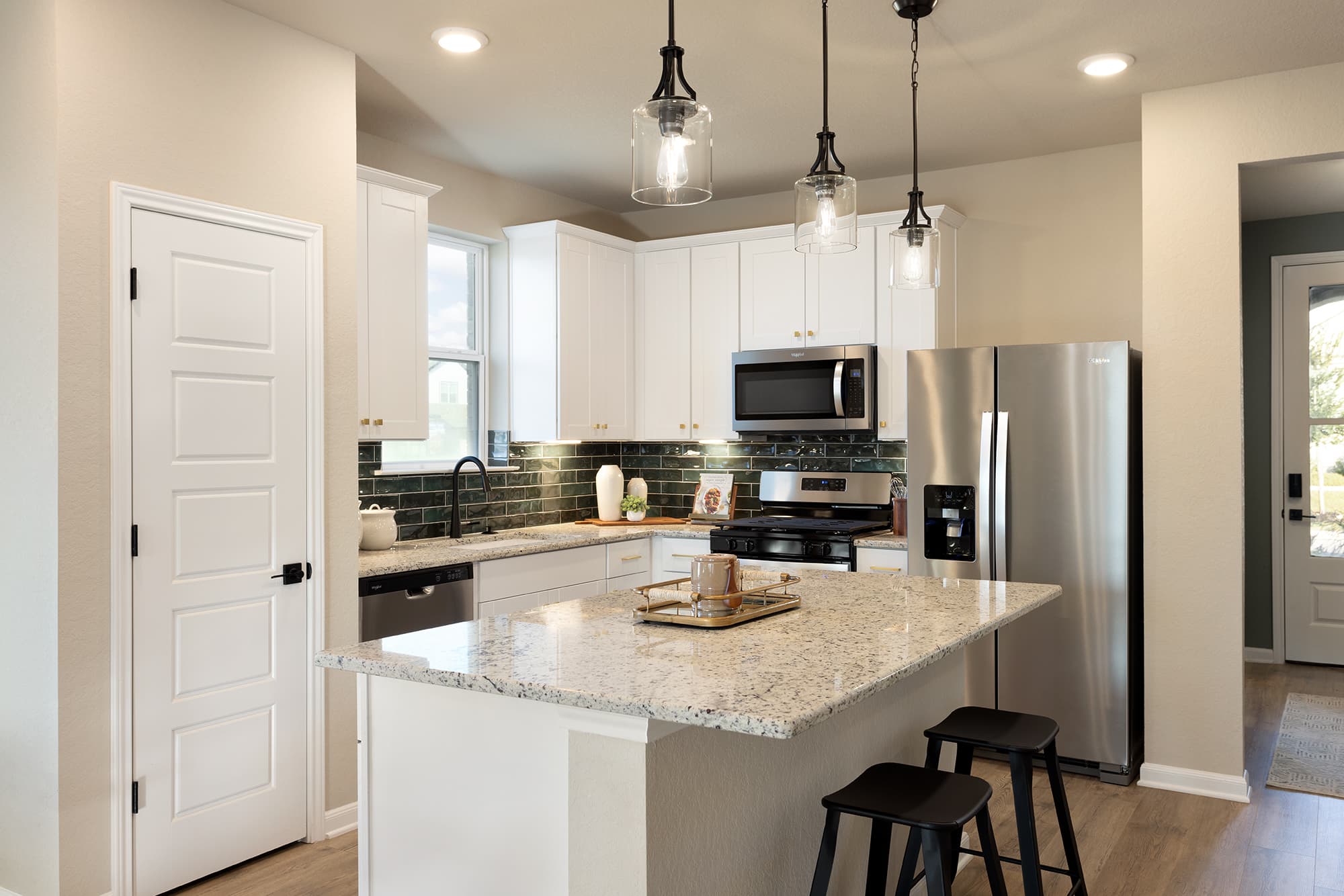 kitchen with green backsplash & island