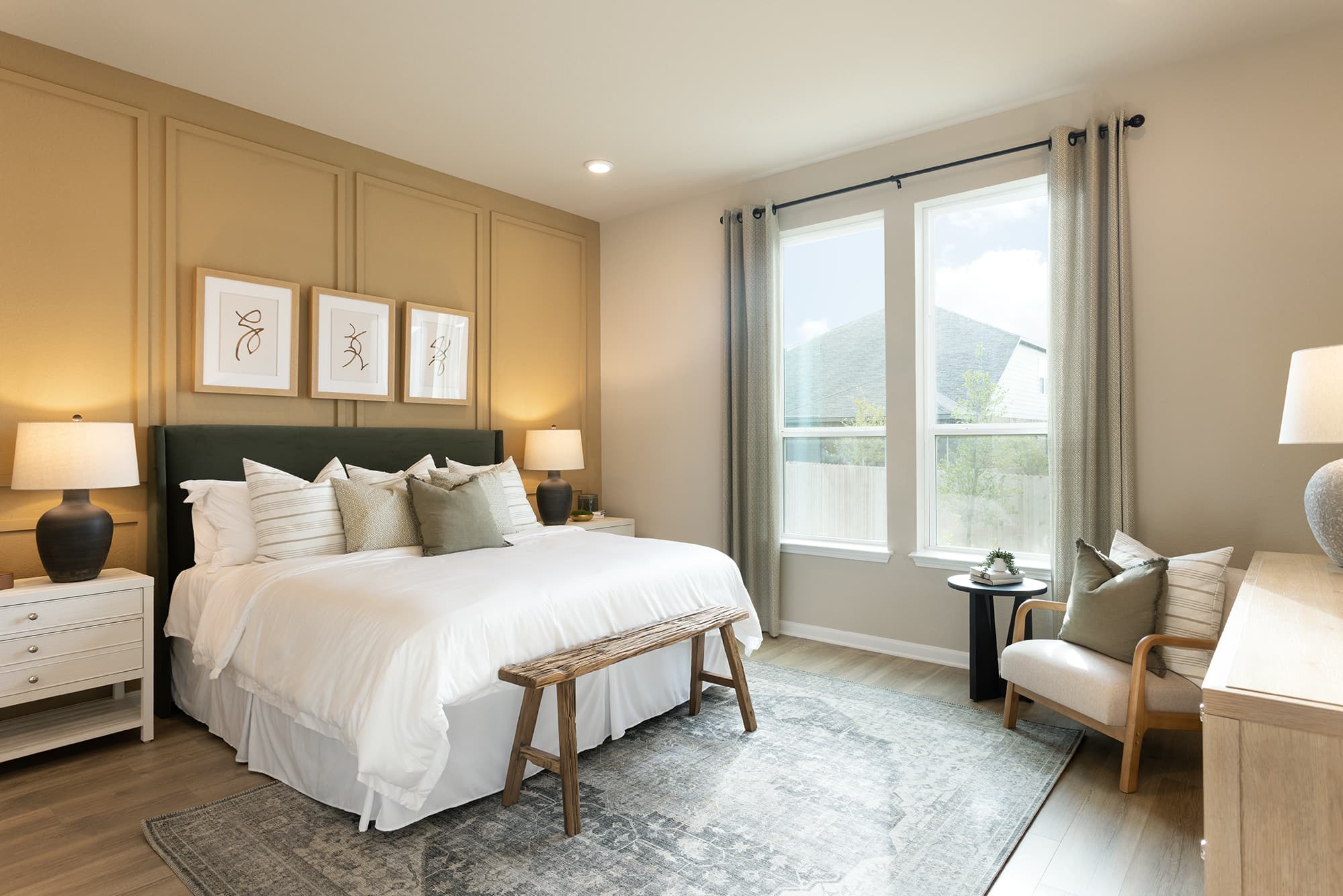 bedroom with brown flooring, rug & windows 