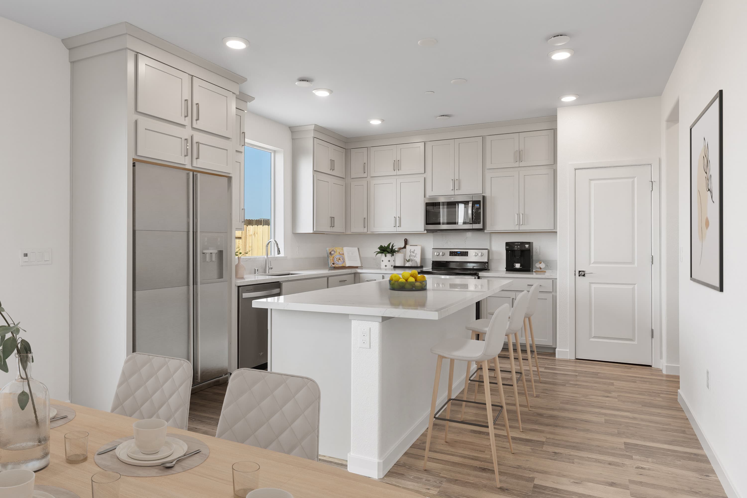 kitchen with wood floors and white cabinets