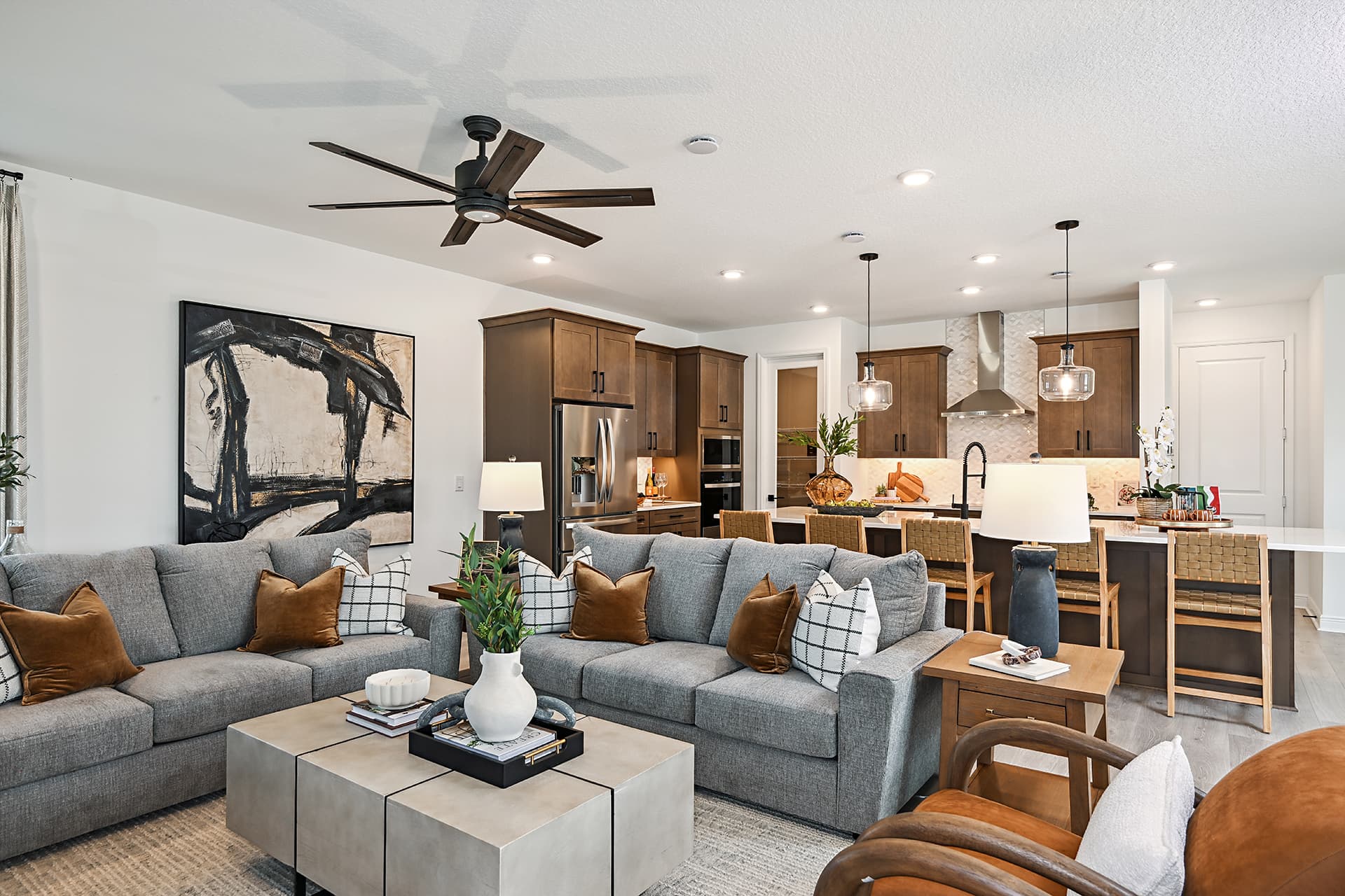 great room with two gray couches and area rug