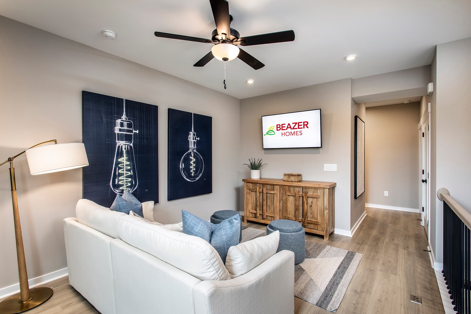 loft with hard-surface flooring, couch, & tv