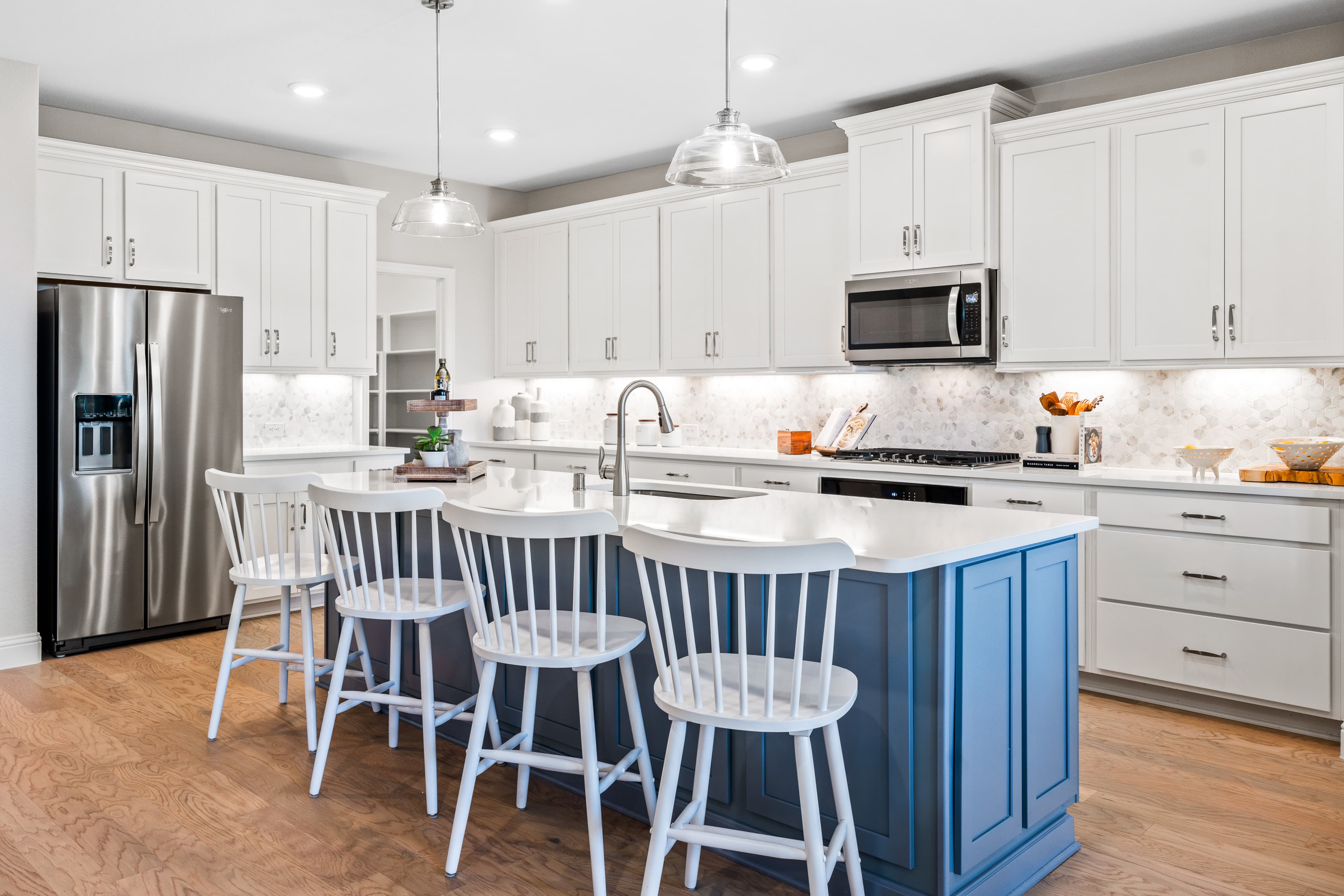open kitchen with white cabinets and wood floors