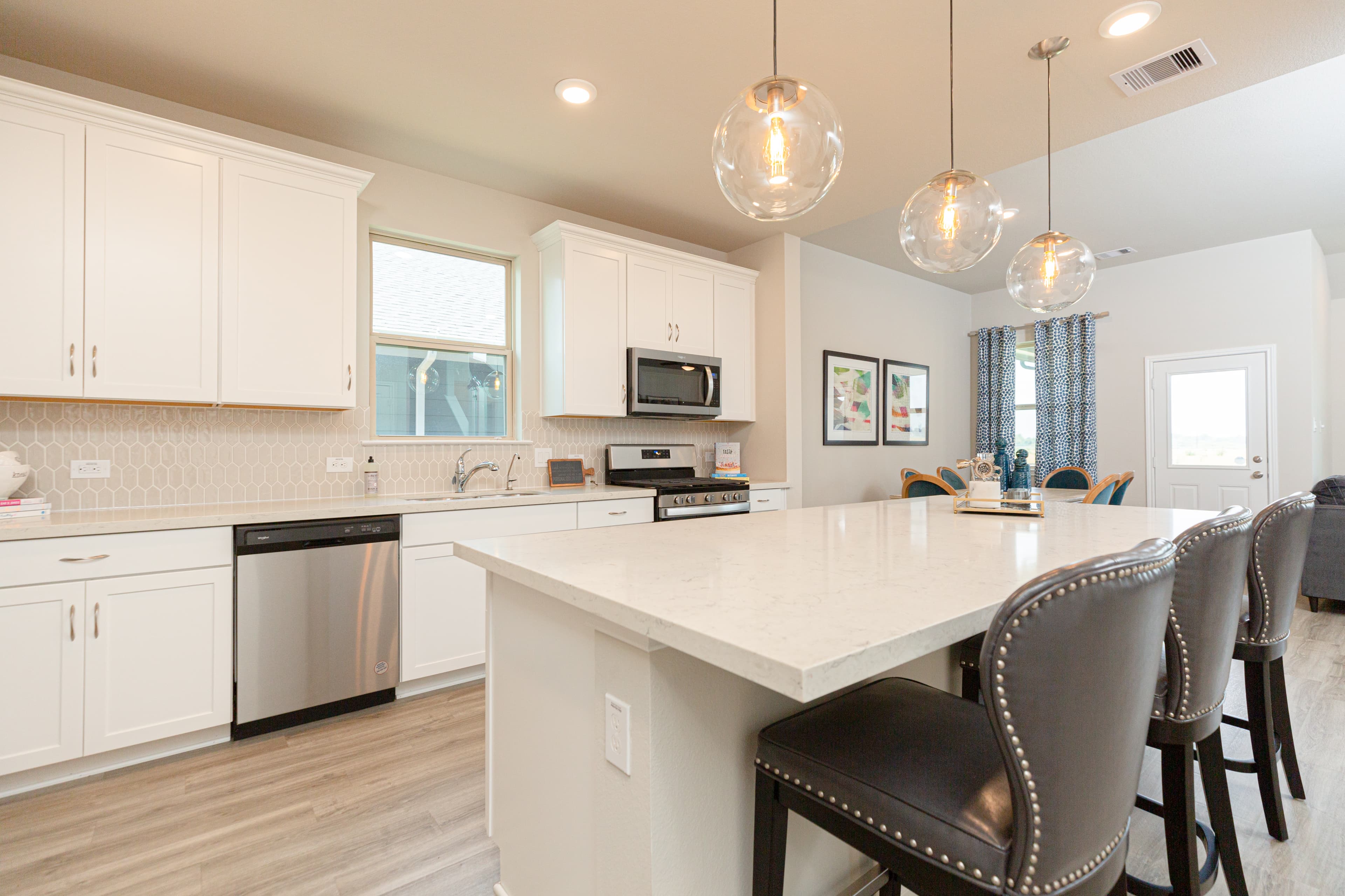 kitchen with white countertops and pendant lights