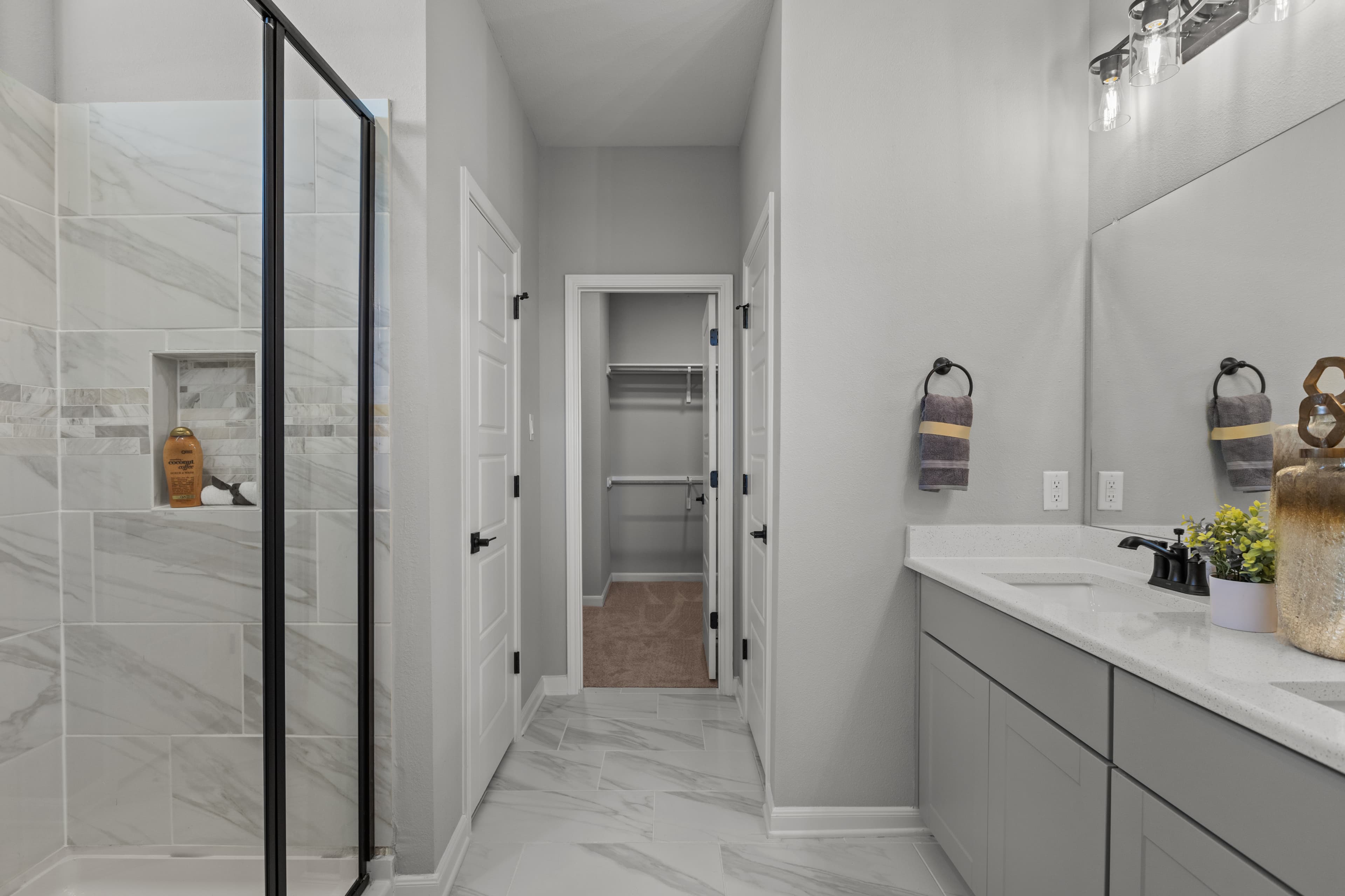 bathroom with granite counters & white cabinets 