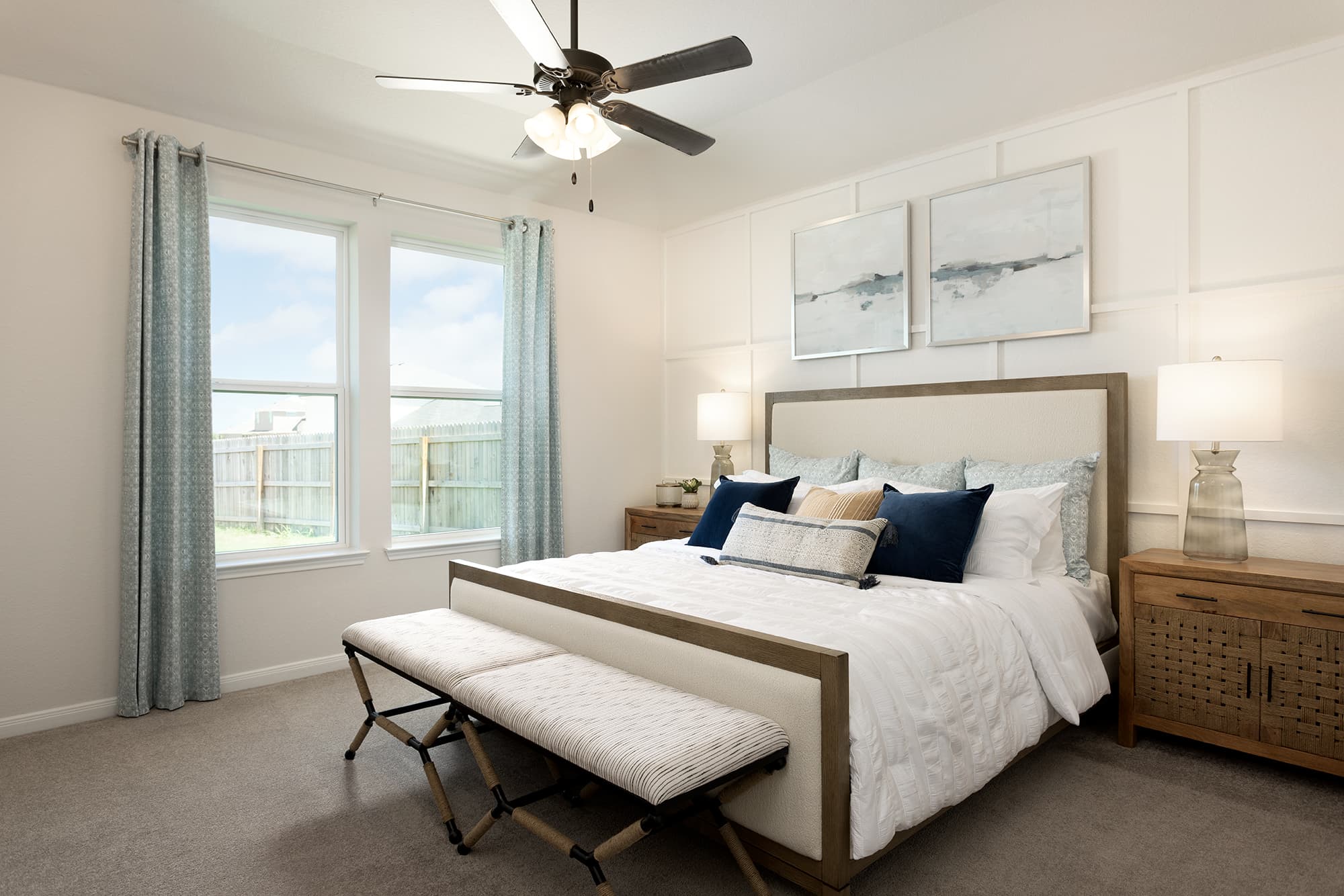 bedroom with accent wall, window & ceiling fan 