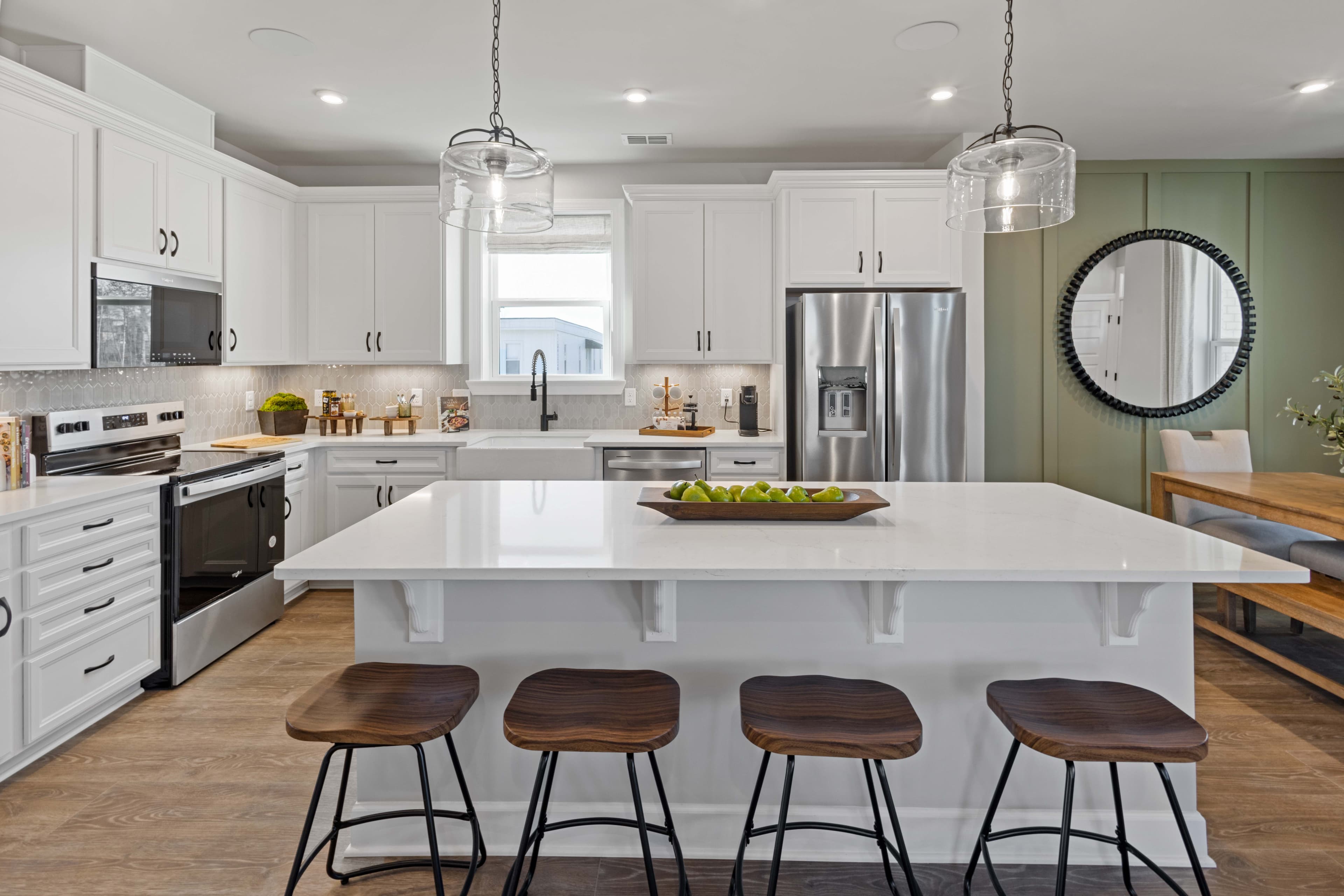 kitchen with white cabinets and green accent wall