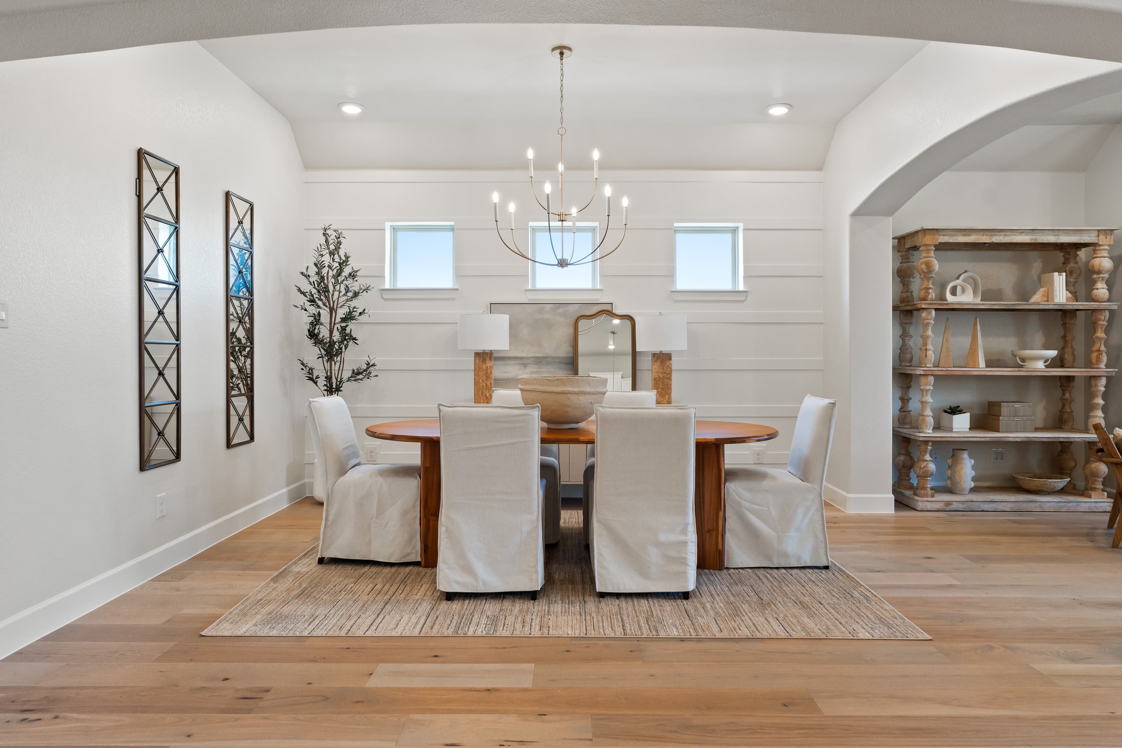 open dining room with wood floors and windows