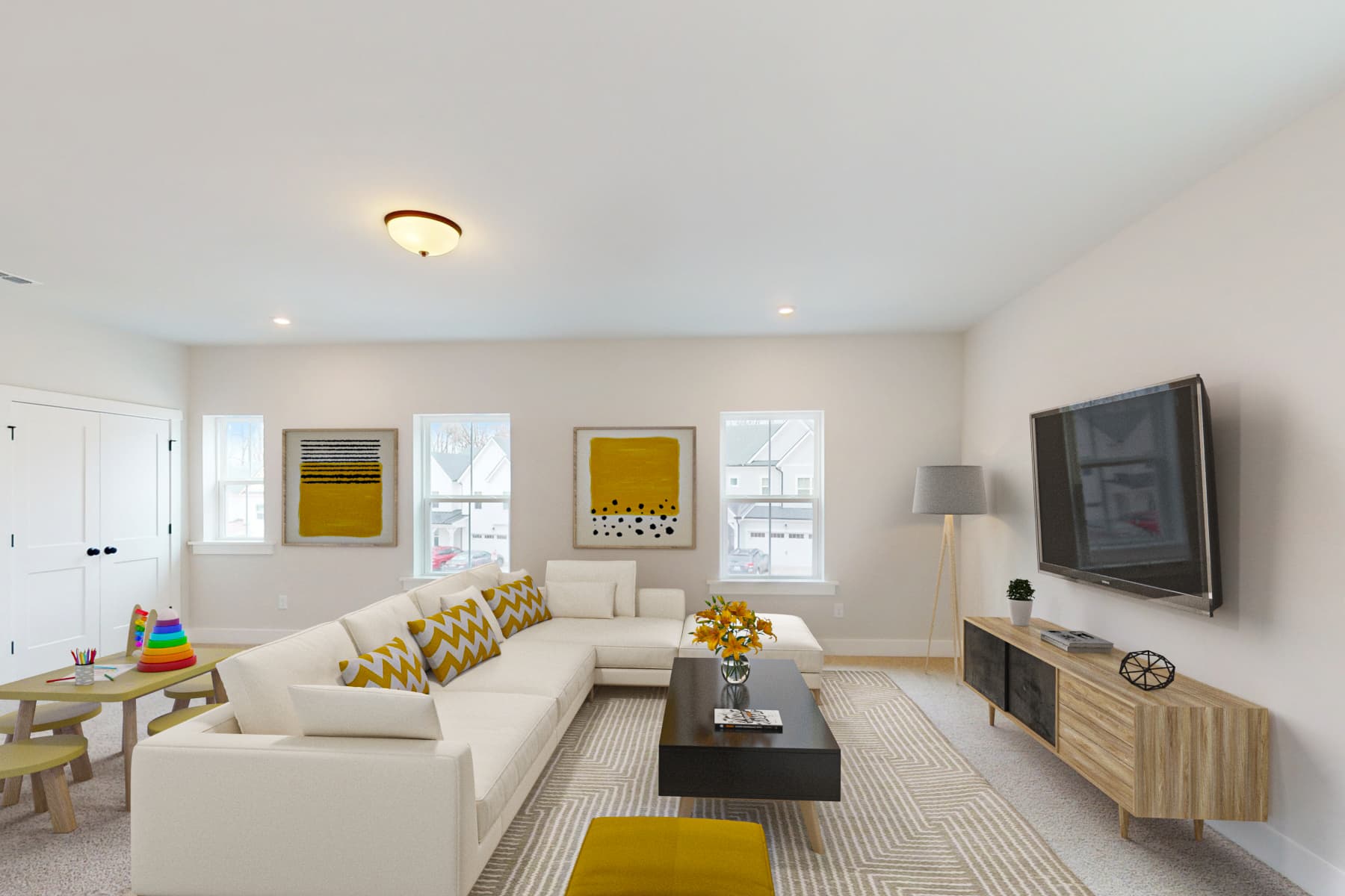 bright loft with a couch facing a TV and art table