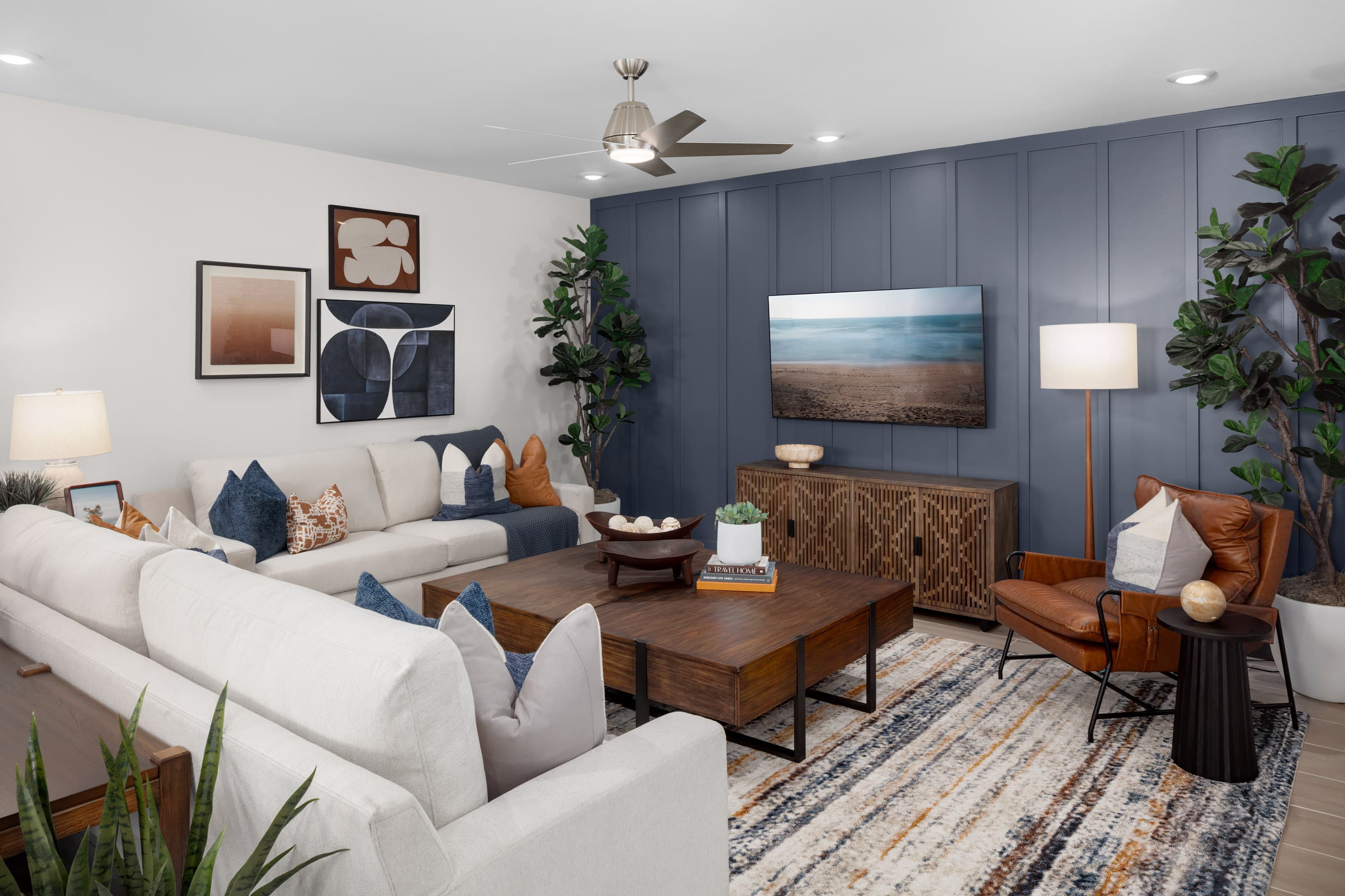great room with blue accent wall and white sofas
