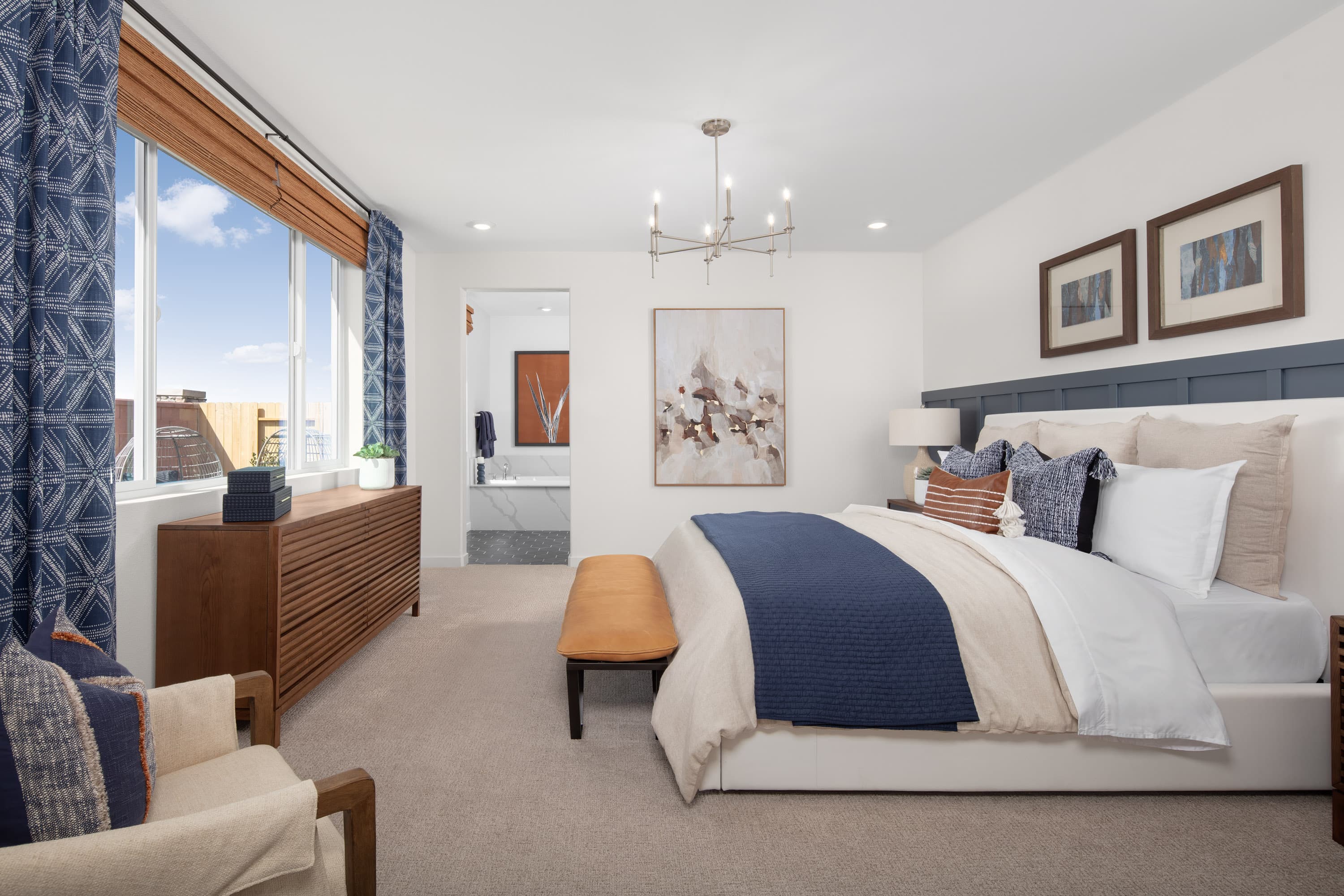 bedroom with white bed and brown dresser