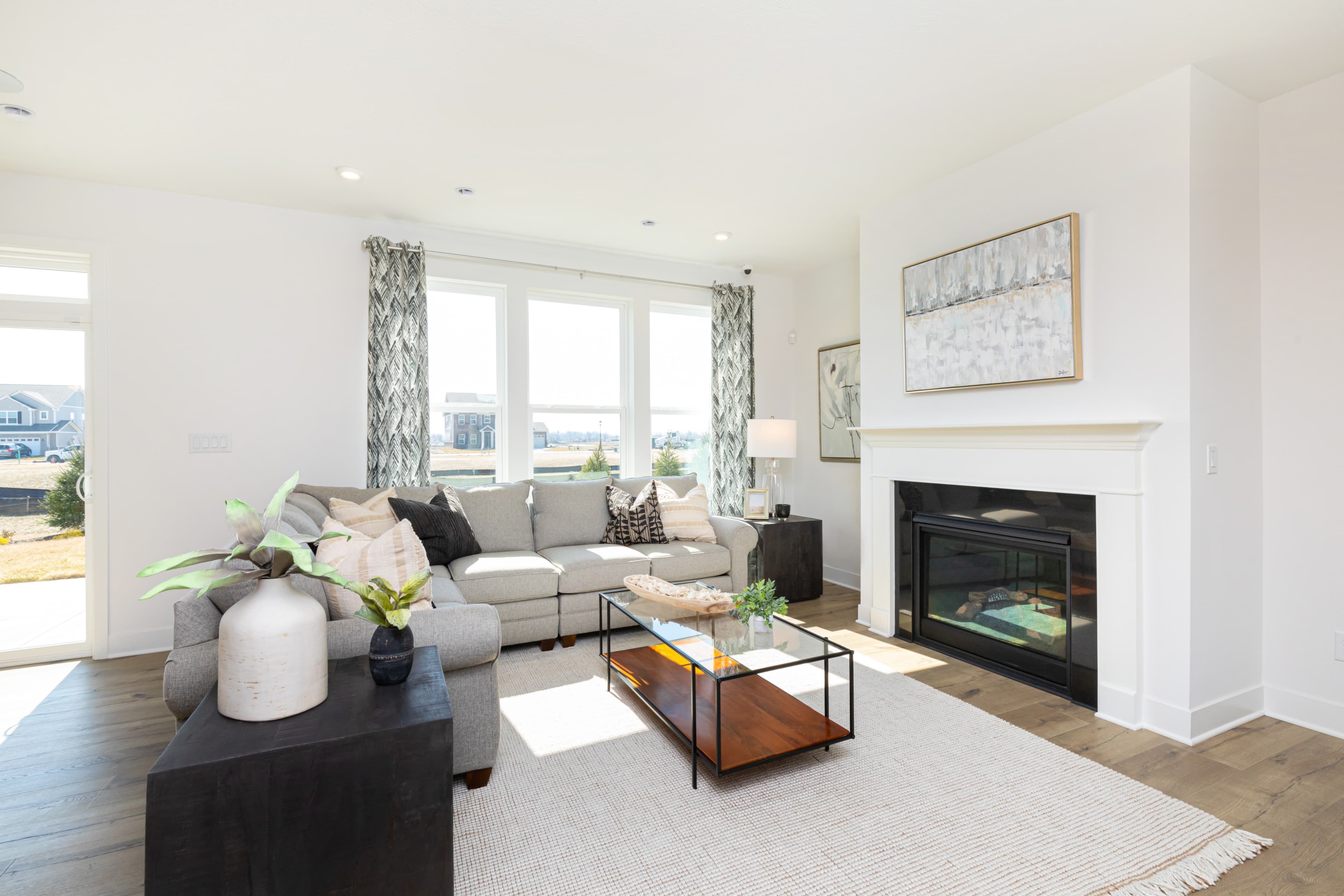 great room with fireplace and hardwood floors 