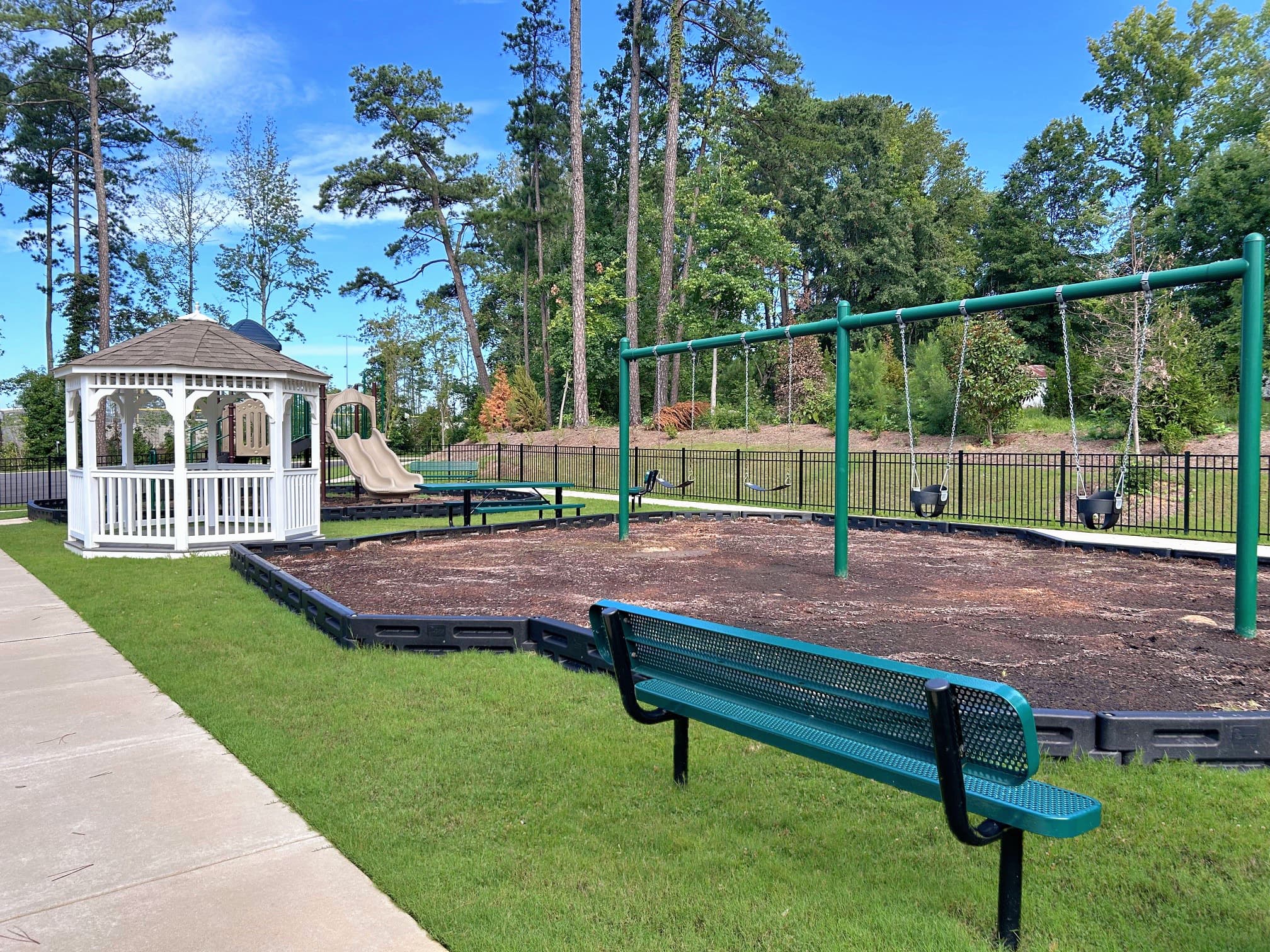 playground with a bench and swings