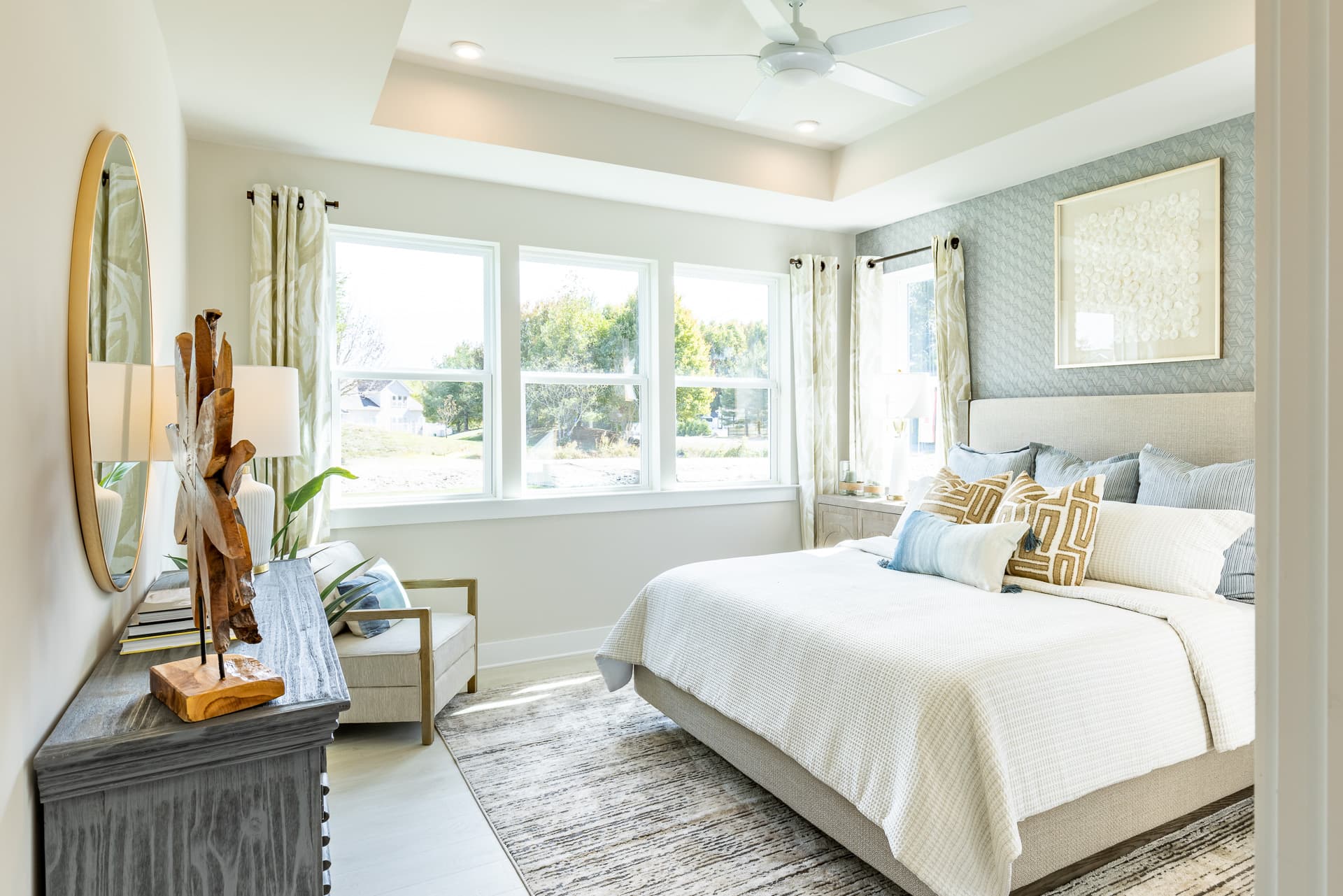 primary suite with a box ceiling and a king bed