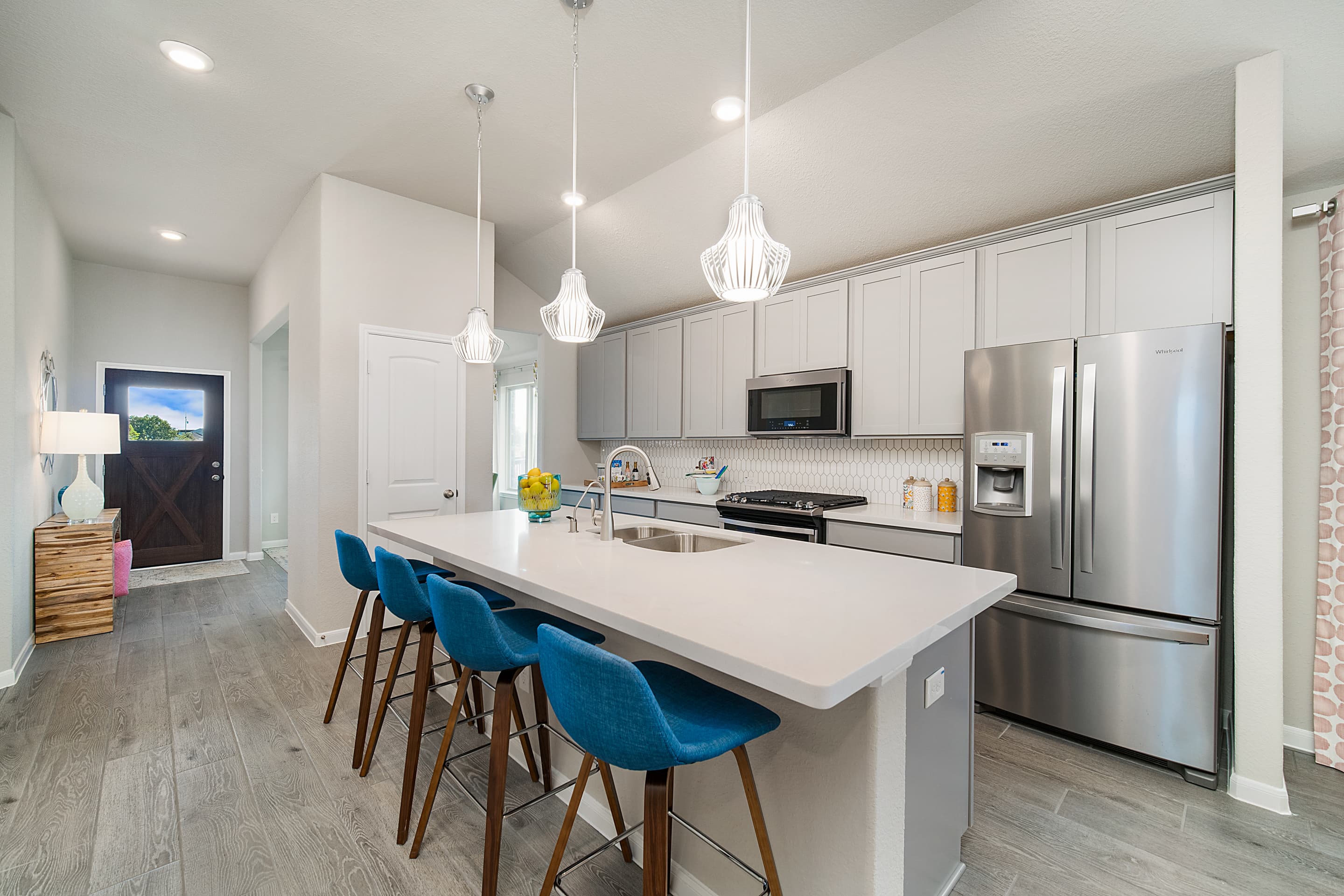 kitchen with large island and blue bar stools