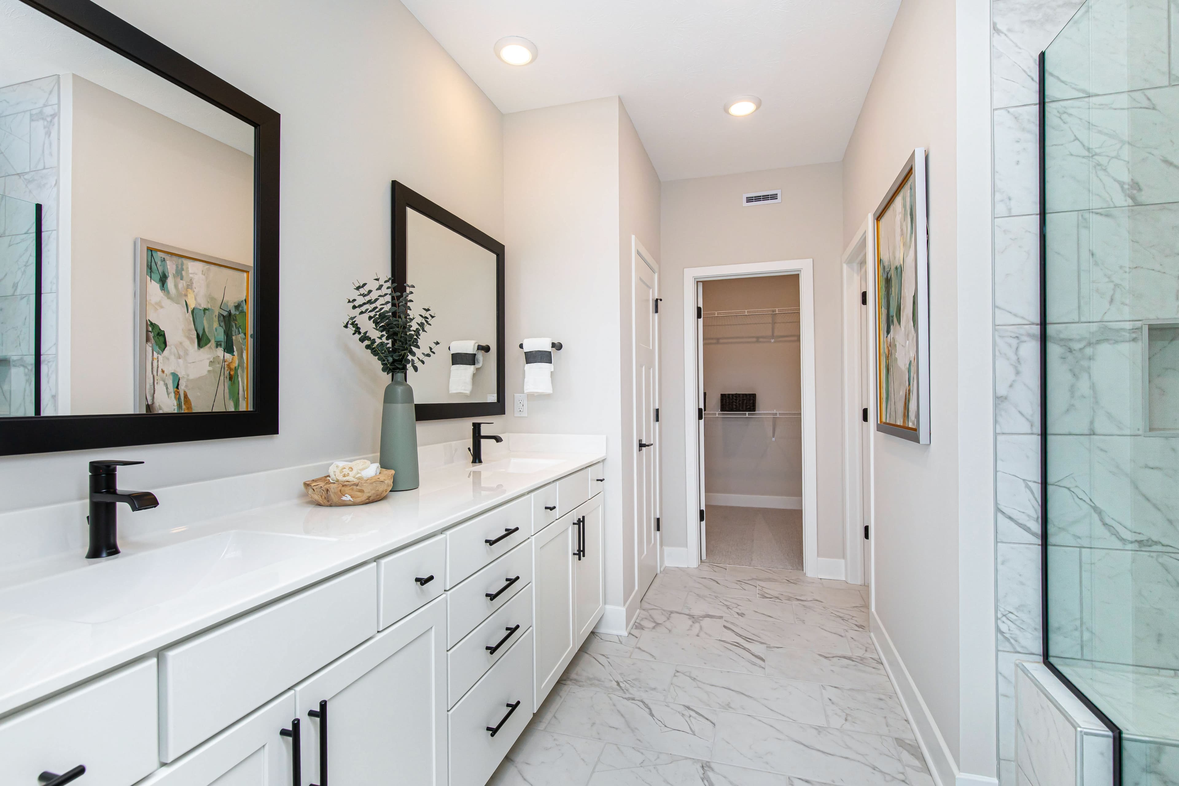bathroom with white tile flooring and dual sinks