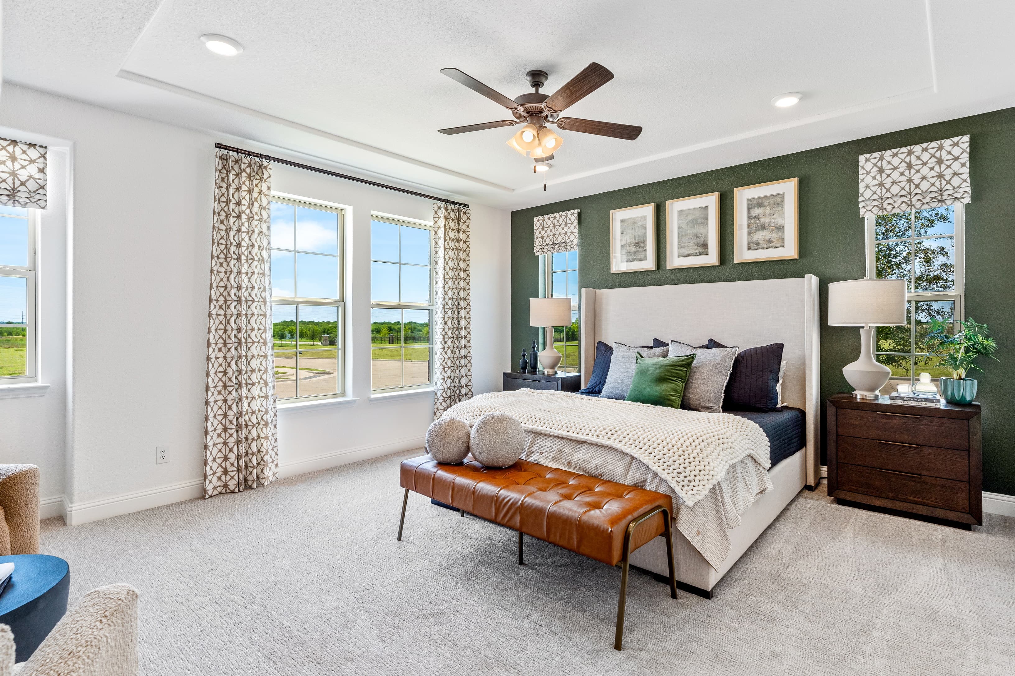 primary bedroom with large windows and carpet