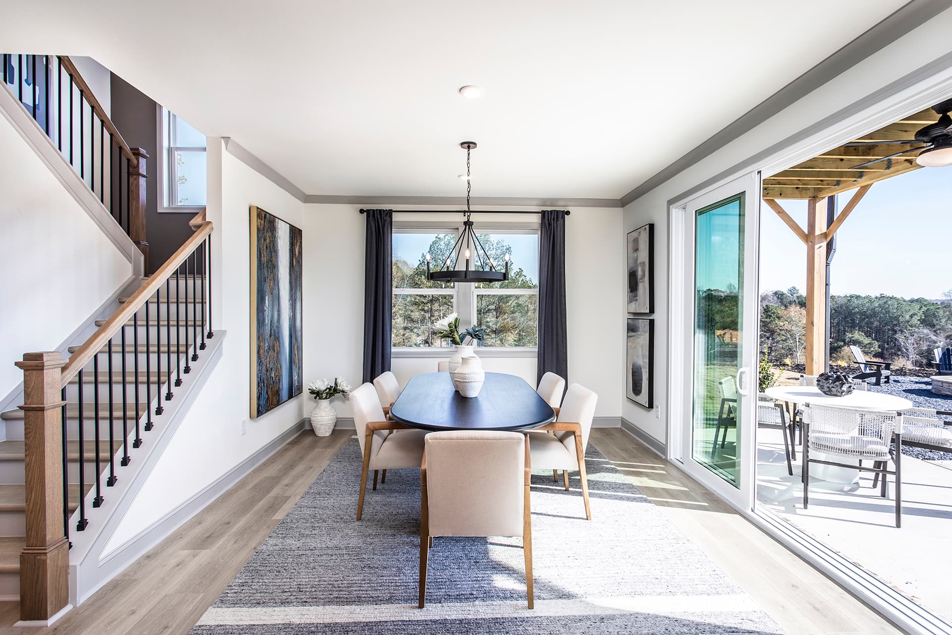 dining room with plank floors and stairs