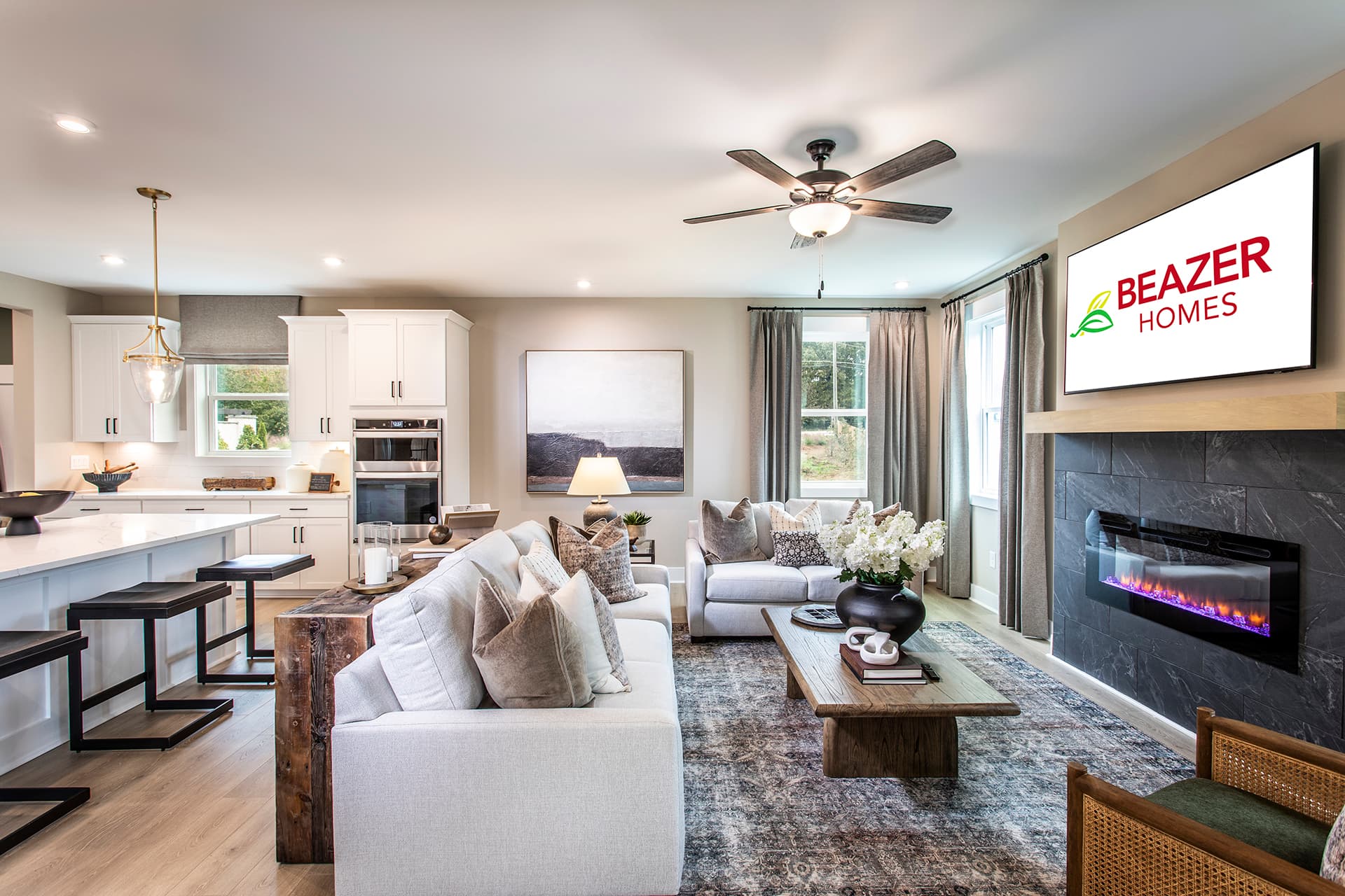 great room with fireplace and light plank flooring
