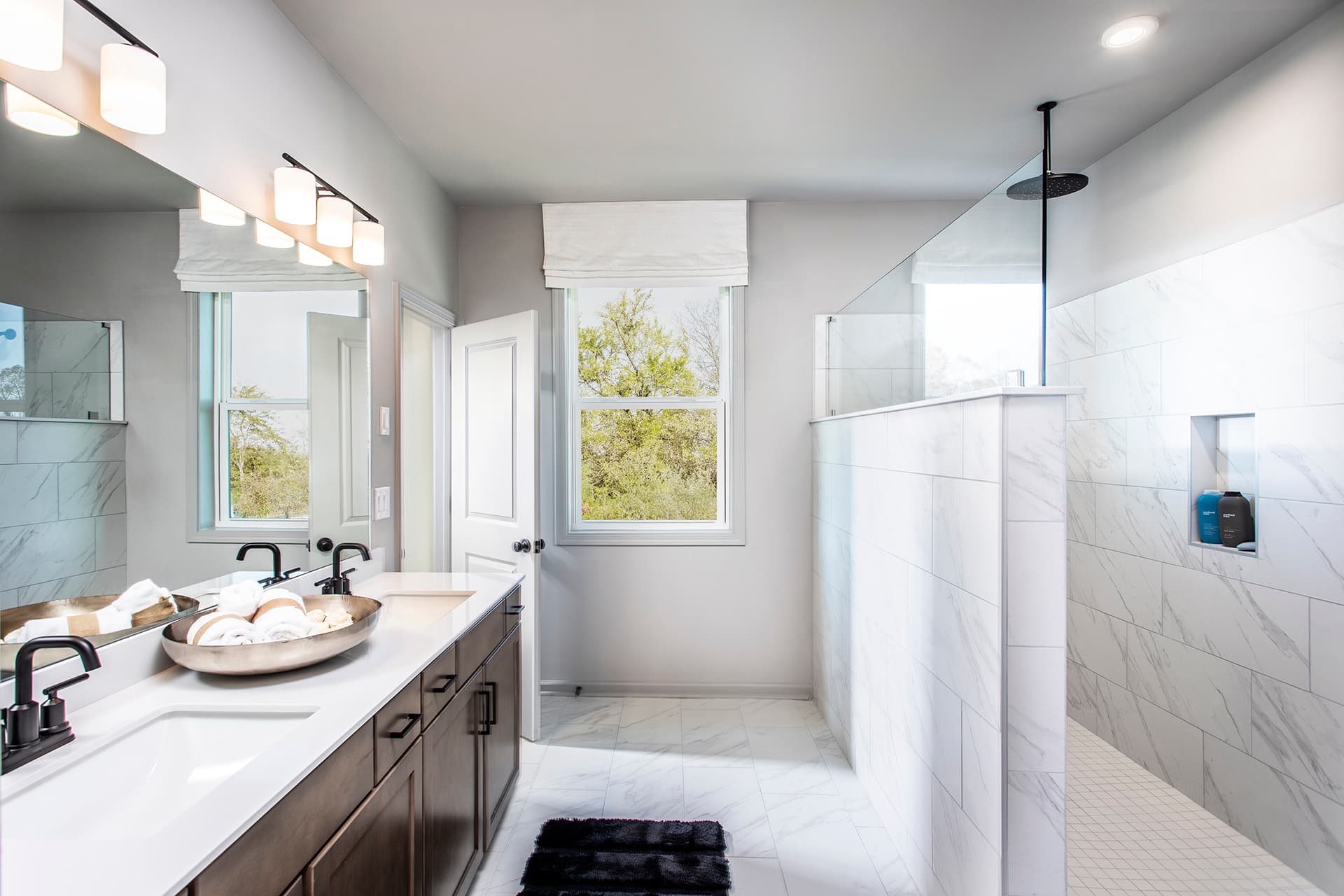 primary bathroom with walk-in shower & dual vanity