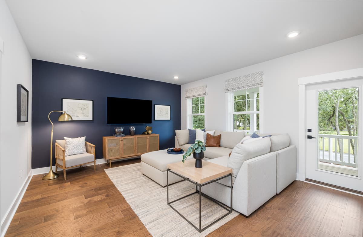 loft with white sectional, tv and reading area