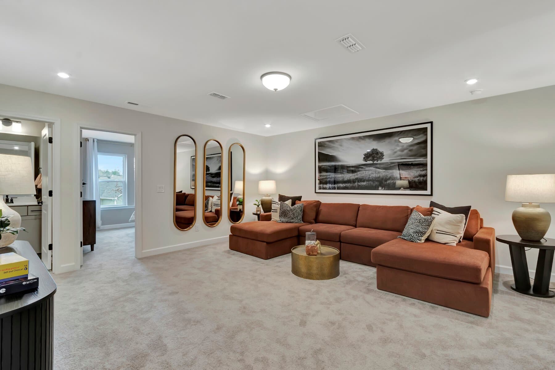 large room with carpet and oversized sectional